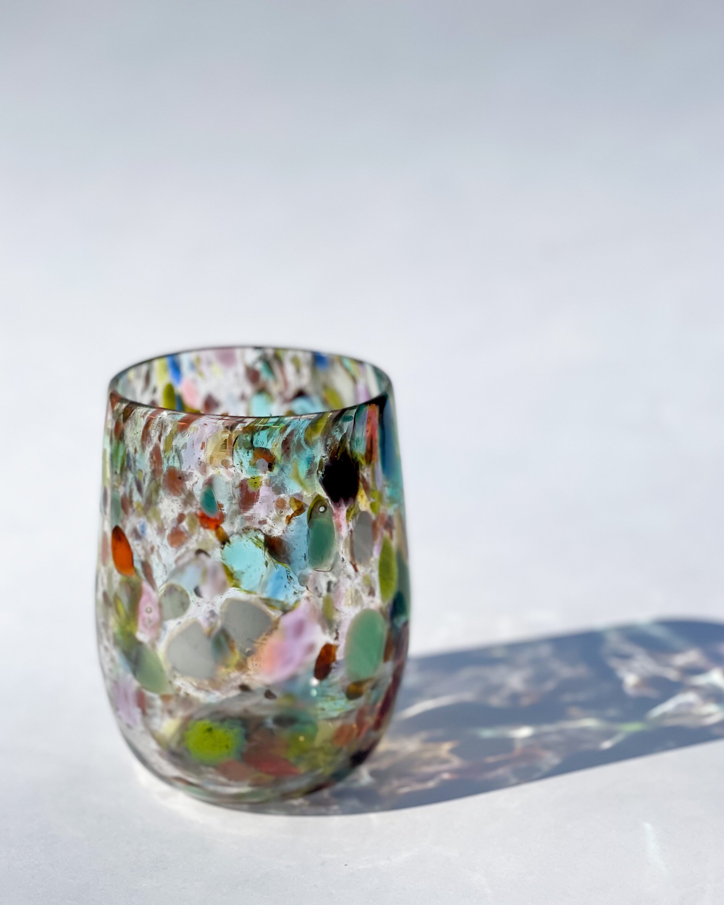 Blown glass stemless wine glass - speckled with many colours
