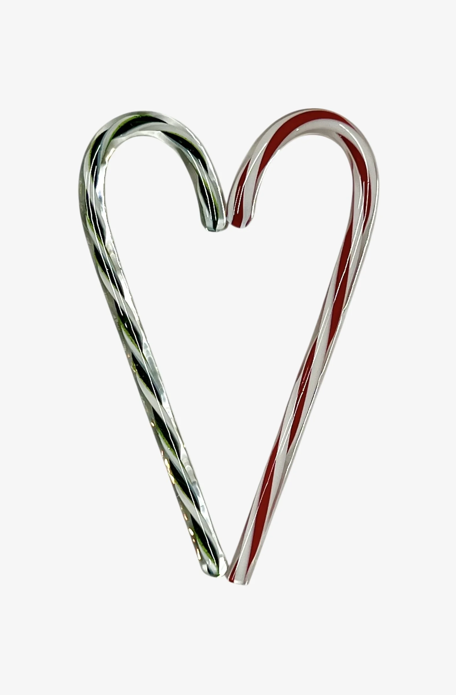 Two candy canes, one with red and white stripes and the other with green and white stripes, arranged to form a heart shape on a white background.