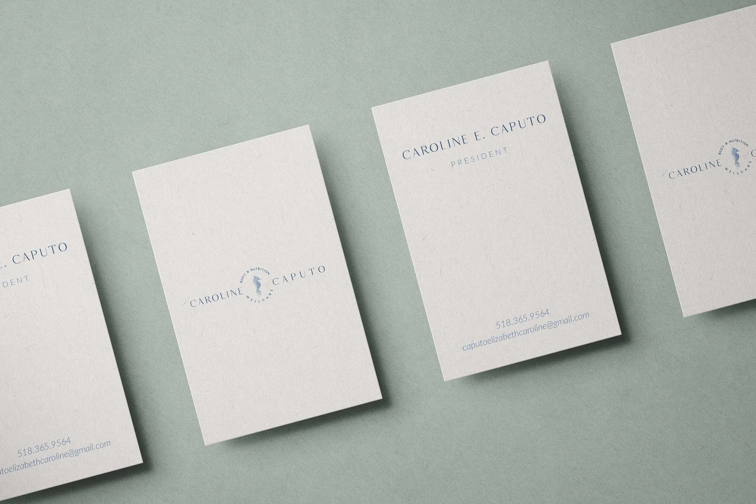 Business cards and logo on a light background.