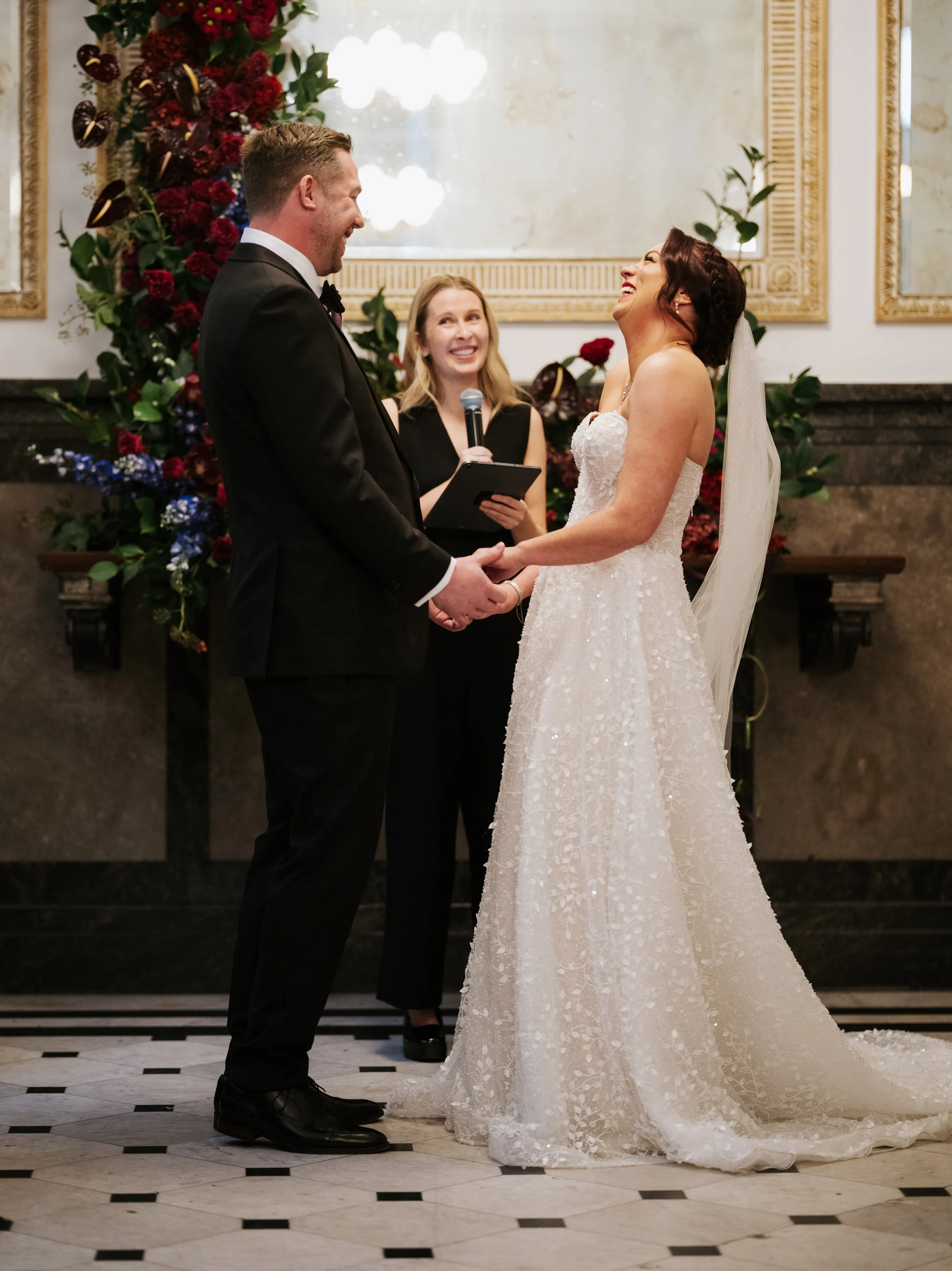 Guests laughing during a personalised wedding ceremony.