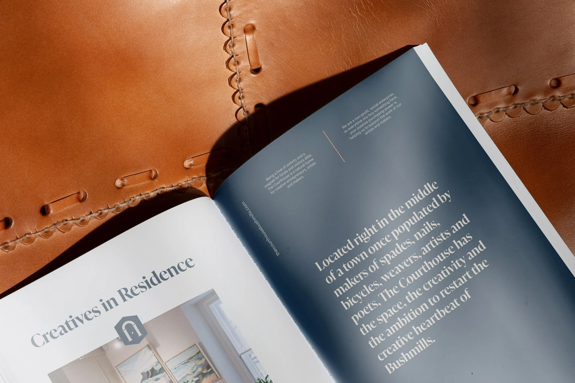An open brochure from The Courthouse Shared Space Creative hub sits open on a leather seat showcasing what the social enterprise is about