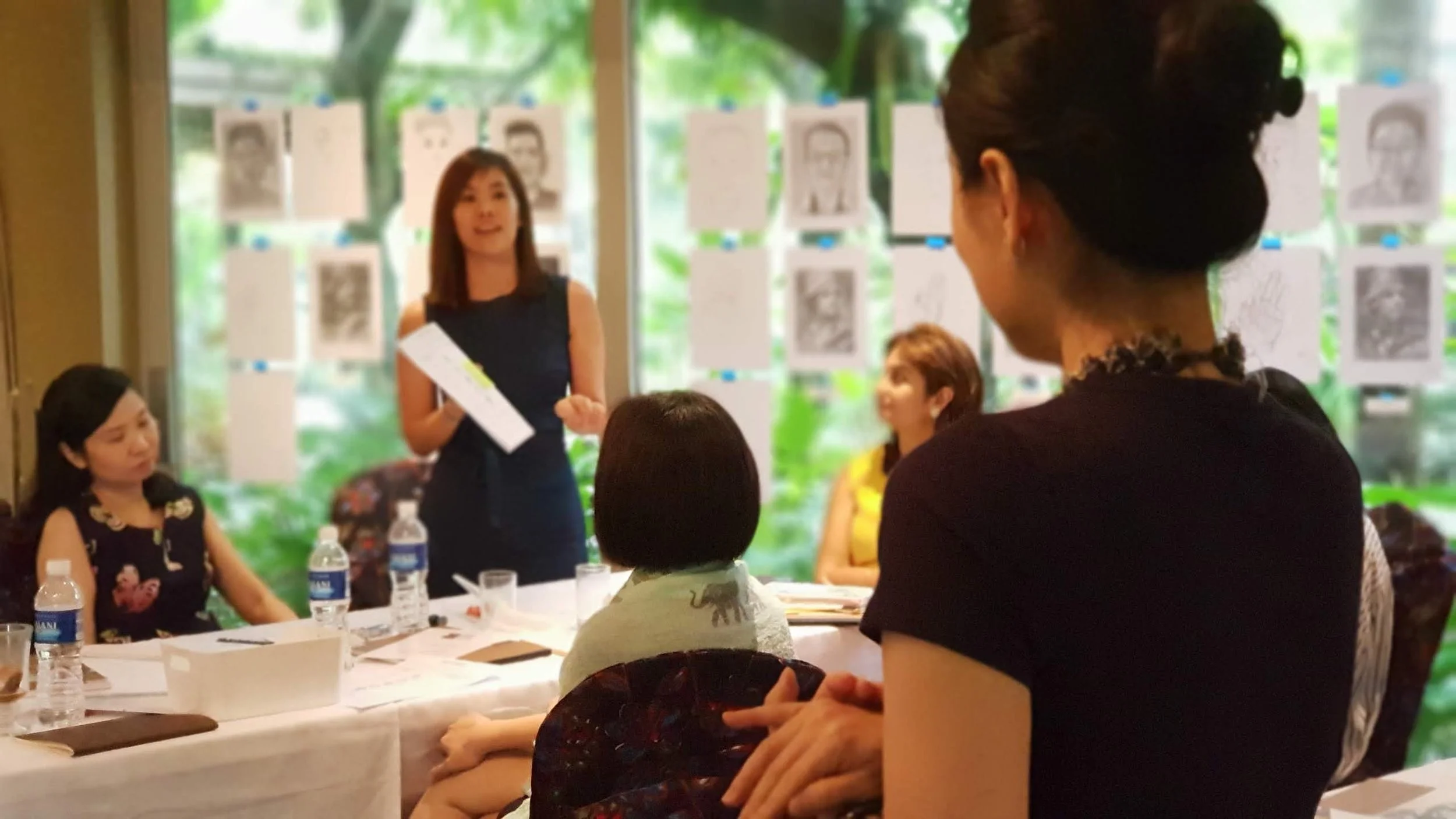 Participant sharing during a corporate learning workshop with Drawing Right in Singapore