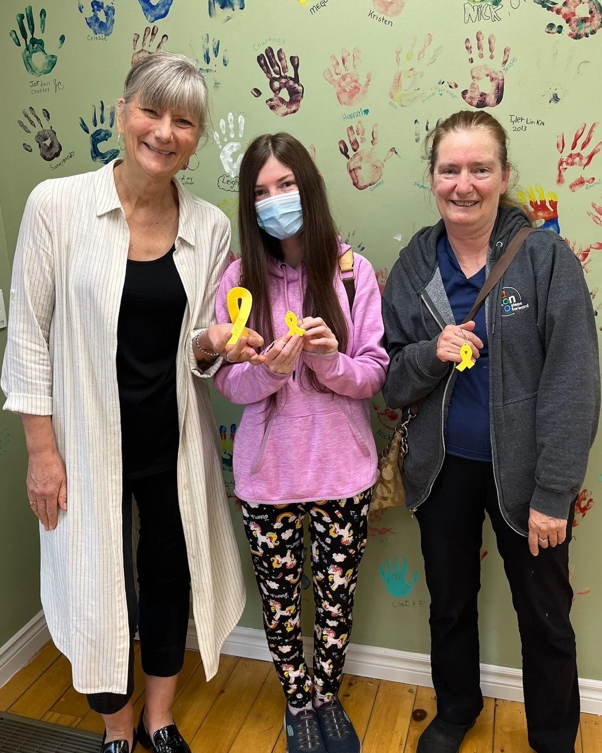 Back in September we posted about these gorgeous keychains and standing ribbons that Rebecca was making to help Childcan families. Rebecca stopped by our office recently to bring us our own and the funds she'd raised through her efforts, $110 so far.