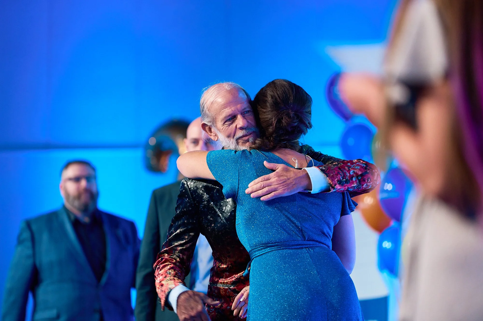 live-event-speaker-on-stage-emotional-hug.jpg