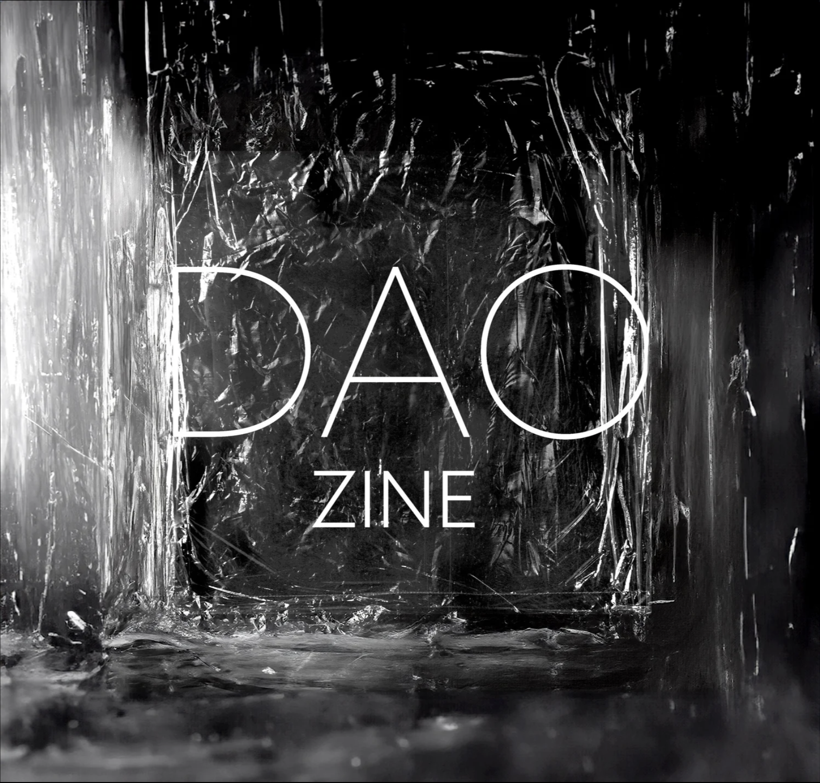 Black and white abstract image with the words "DACZINE" in white, minimalist font in the center. The background appears textured with crinkled and reflective surfaces, giving an artistic and edgy feel.