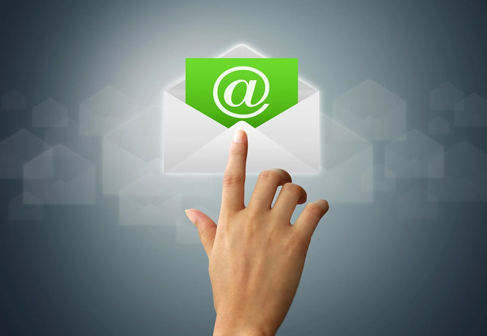 A person's hand with an extended finger pointing at a digital envelope with a green email icon and '@' symbol, surrounded by faint email icons in the background.
