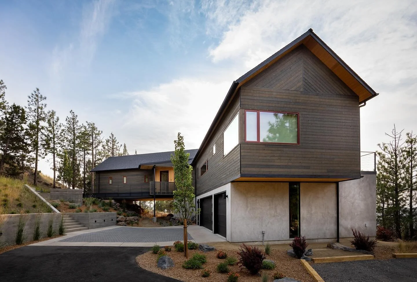 Our recently completed Awbrey Treehouse. The master wing spans over the landscape gently meeting the slope on the uphill side. Guests arrive to at the street above the home and enter into the upper level living areas across a steel entry bridge. 

#i