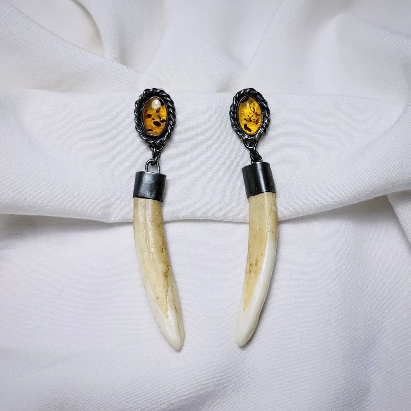 Baltic Amber, alligator teeth, sterling silver. $250.