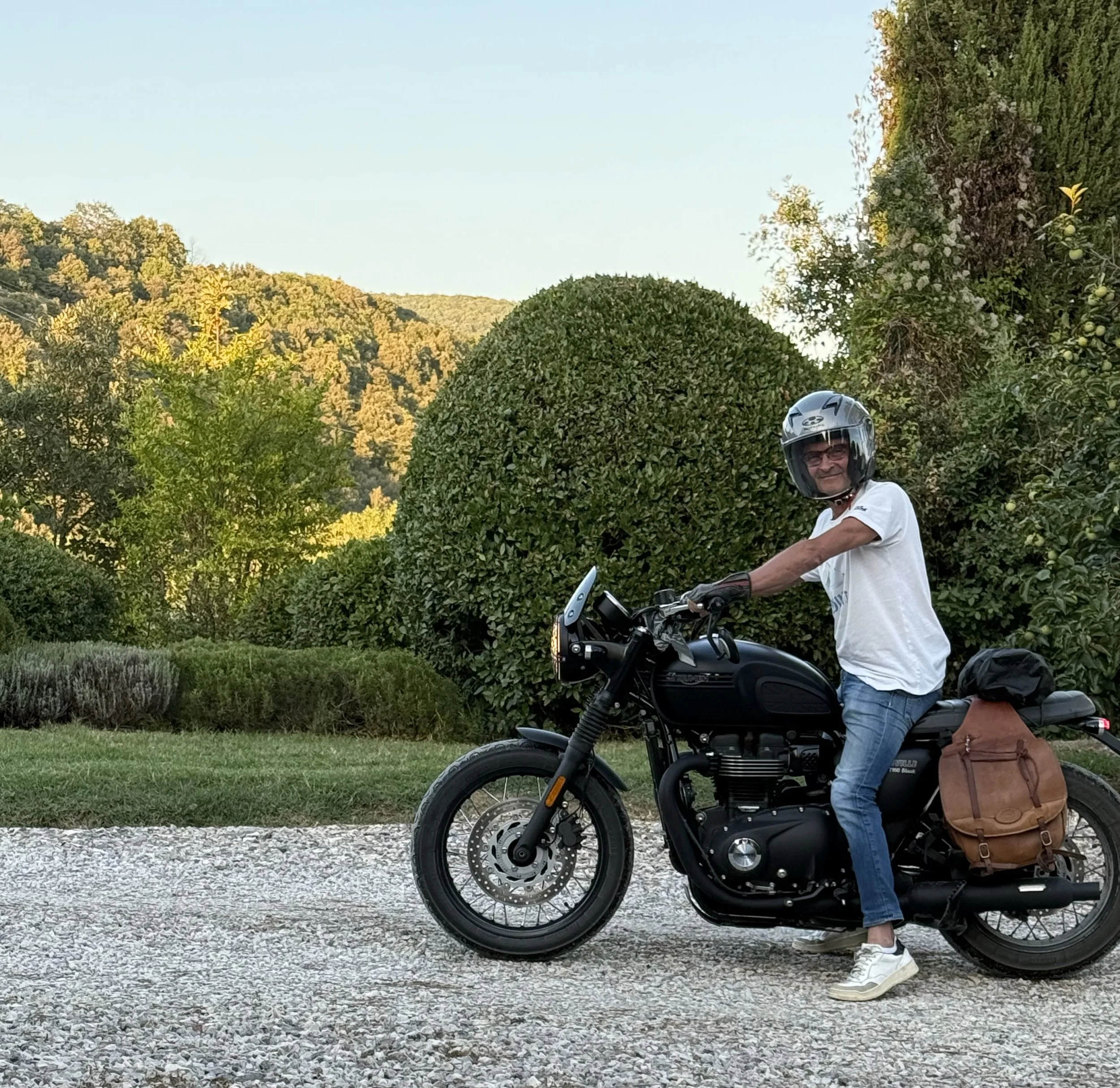 Man riding motorcycle leather saddlebag Tuscany