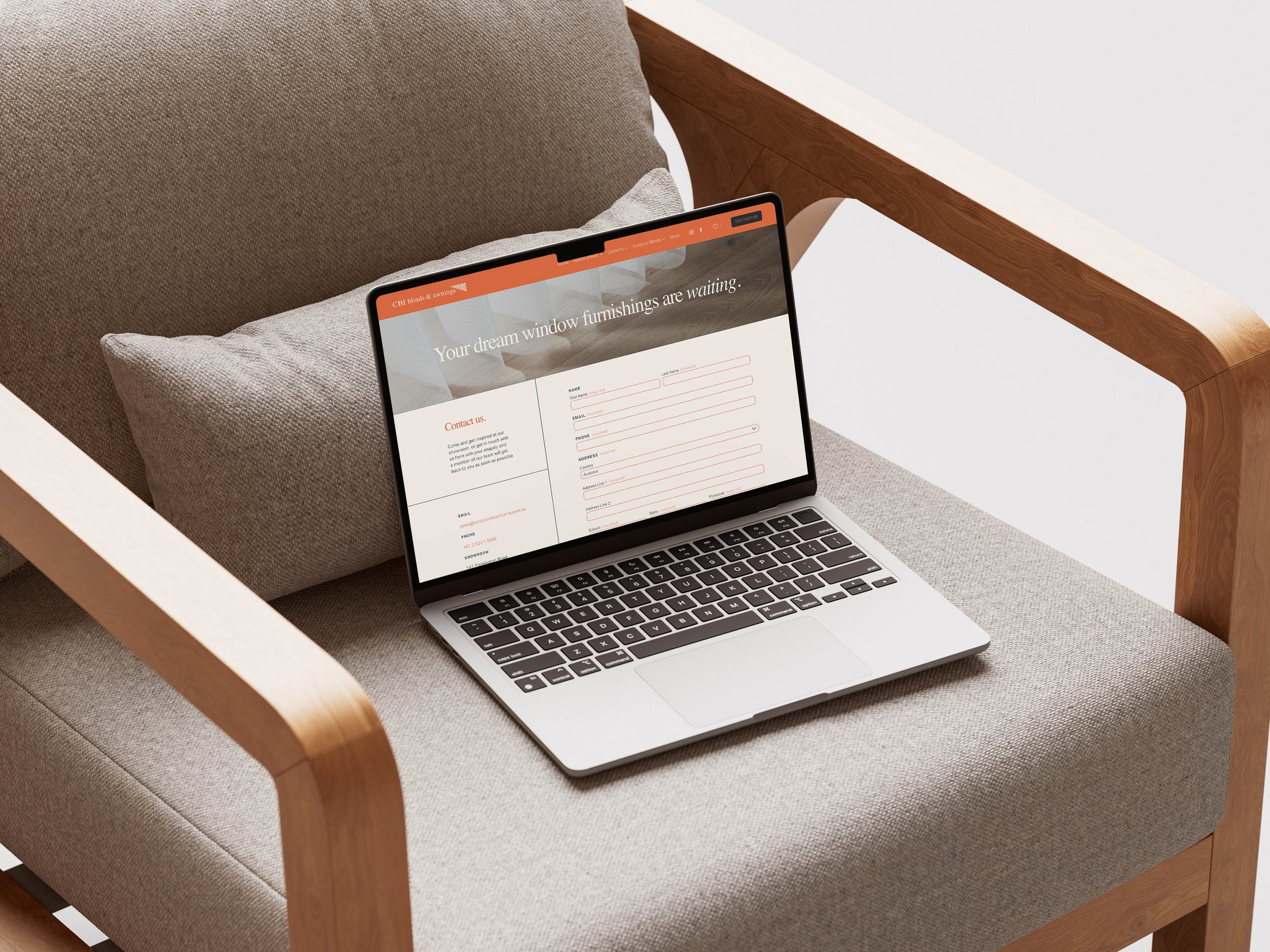 Raego Creative - CBI Blinds and Awnings Website - Contact Page on Macbook Screen Sitting on a Neutral Chair.jpg