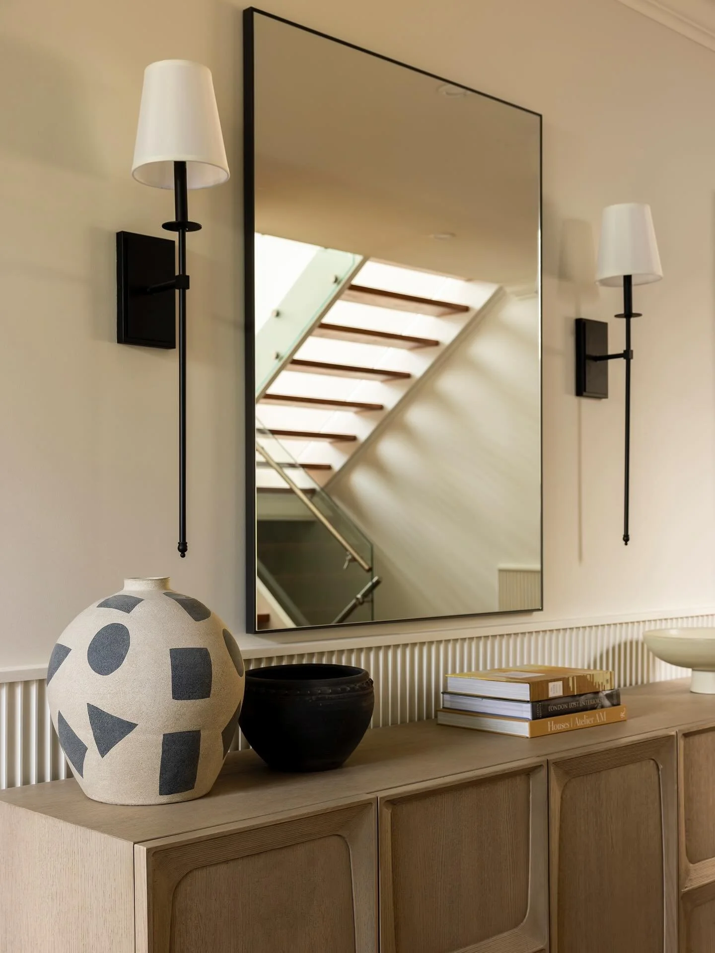 Updating the entry to match the vibe of the rest of the house ✨ 

We added some large art for impact, applied wall moulding for that extra layer of texture, and a pair of oversized sconces to warm it all up. 

Design &amp; Styling- @t.h.e.style.c.o 
