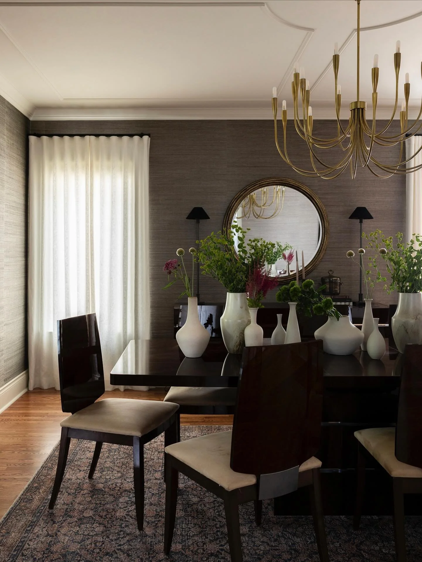 The dining room started as a blank canvas, so we added a textural grasscloth to the walls, a charming trim detail to the ceiling, and an effortless linen drape to keep the space feeling relaxed rather than stuffy.

Design &amp; Styling @t.h.e.style.c