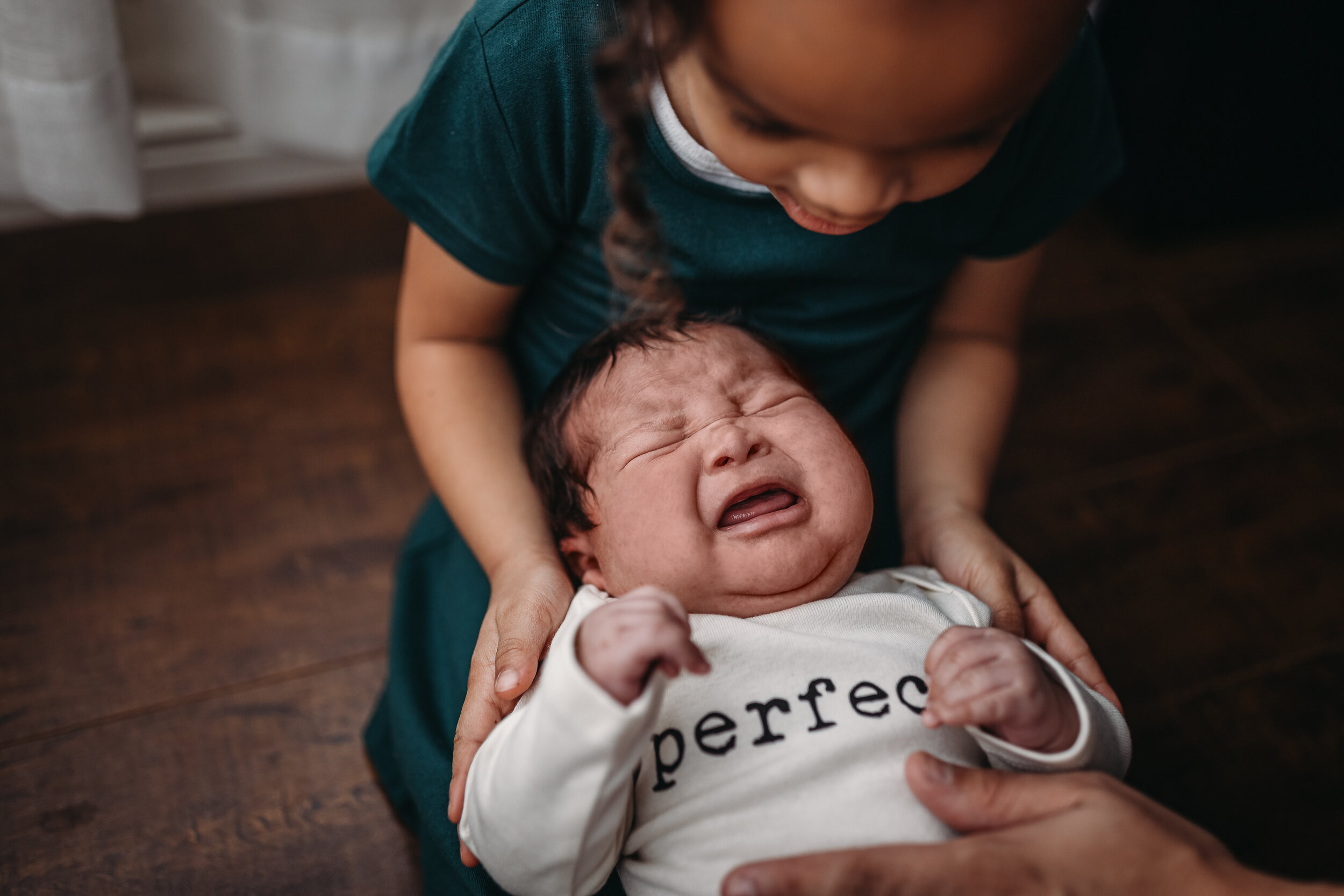 newborn boy crying - Lifestyle Newborn Photos in  clients Home with Baby Boy and family photo and outfit ideas