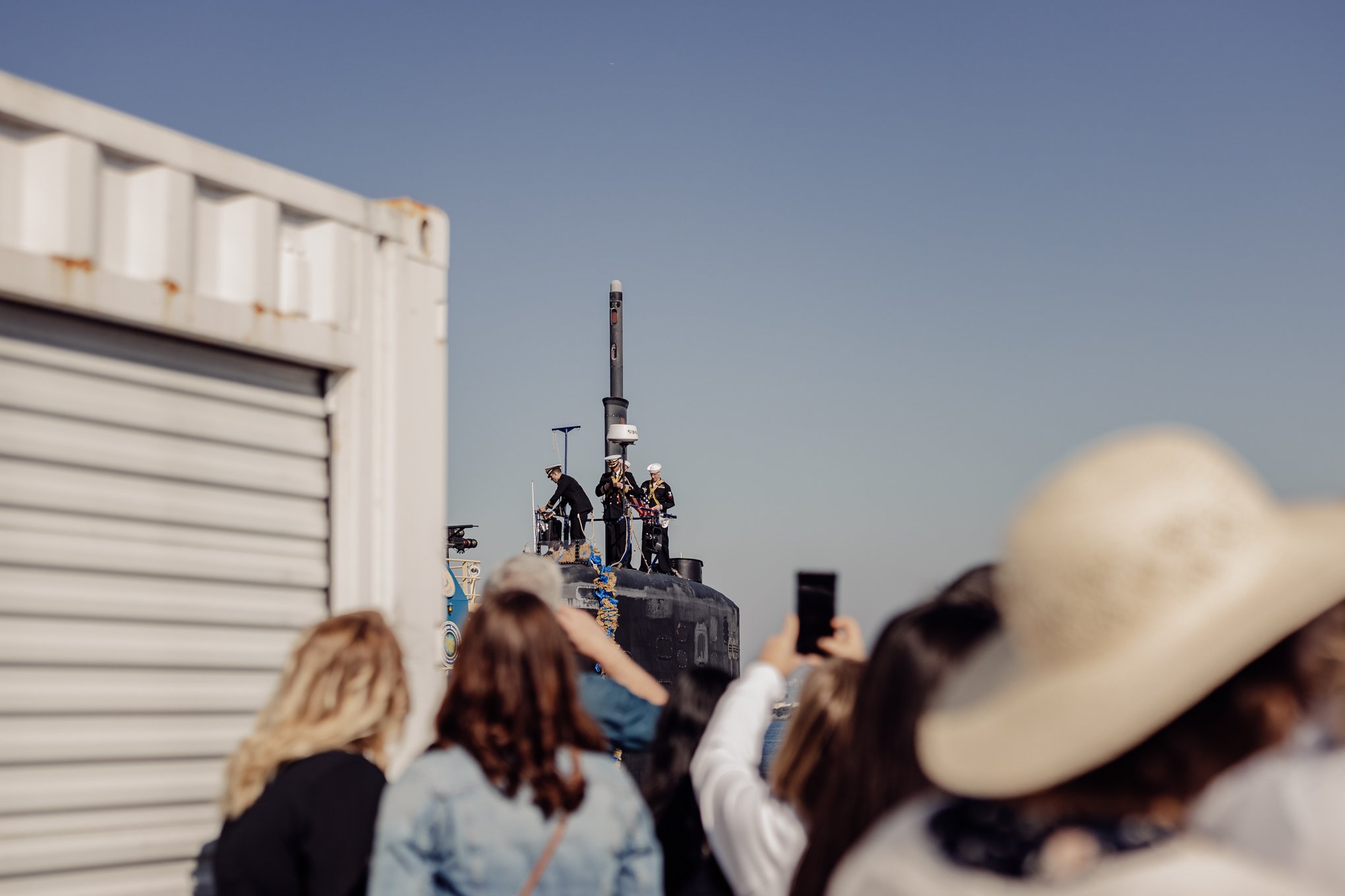 Officers on top of US Navy Submarine at homecoming