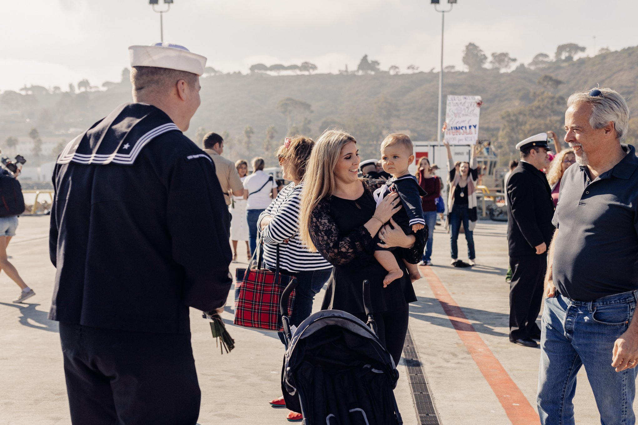 Sailor seeing child for first time after long deployment on submarine in pacific ocean. 