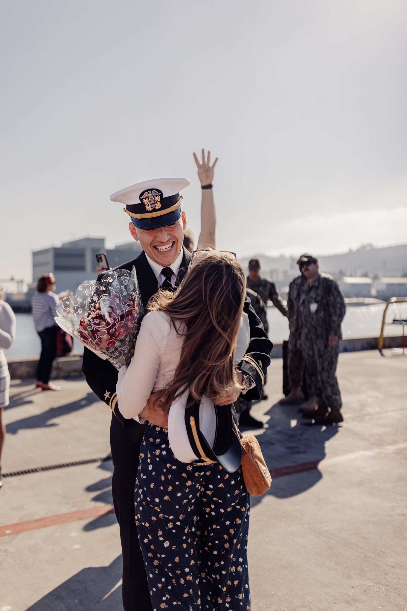 Fiancee of Navy officer hugging after long submarine deployment in San Diego ca