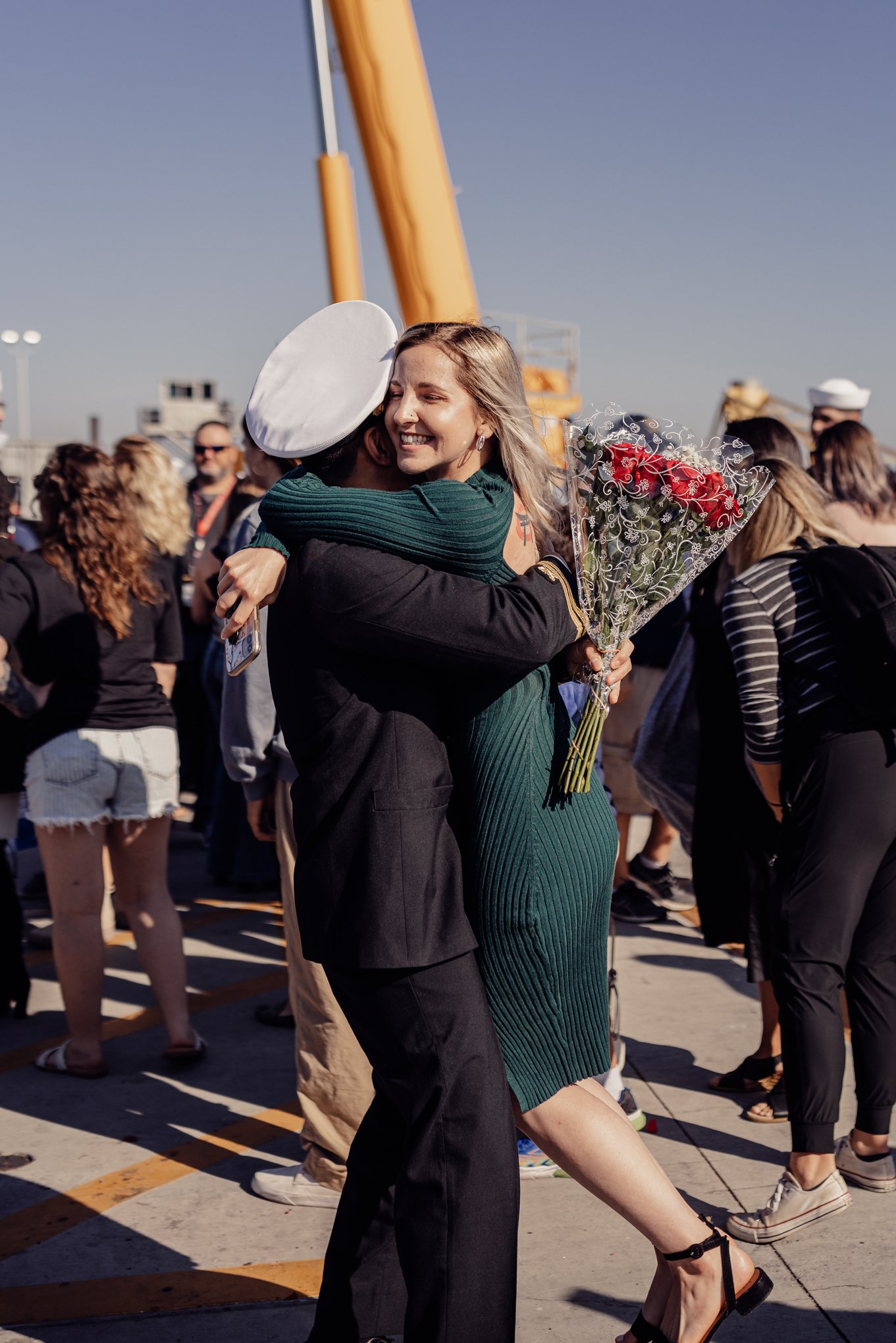 Couple embracing each other at Homecoming for uss Hampton in point loma CA