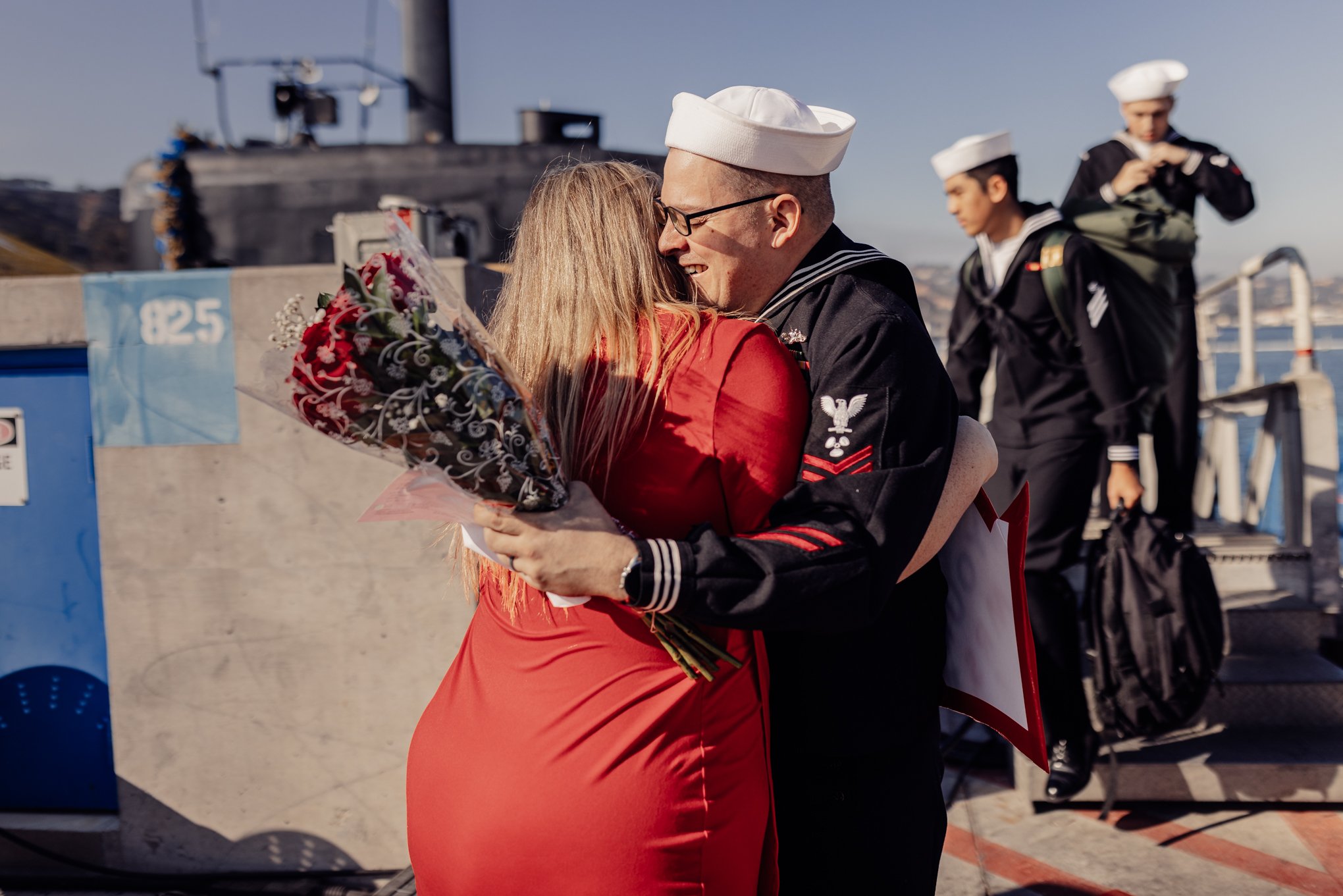 Crying sailor hugging wife at submarine Homecoming 