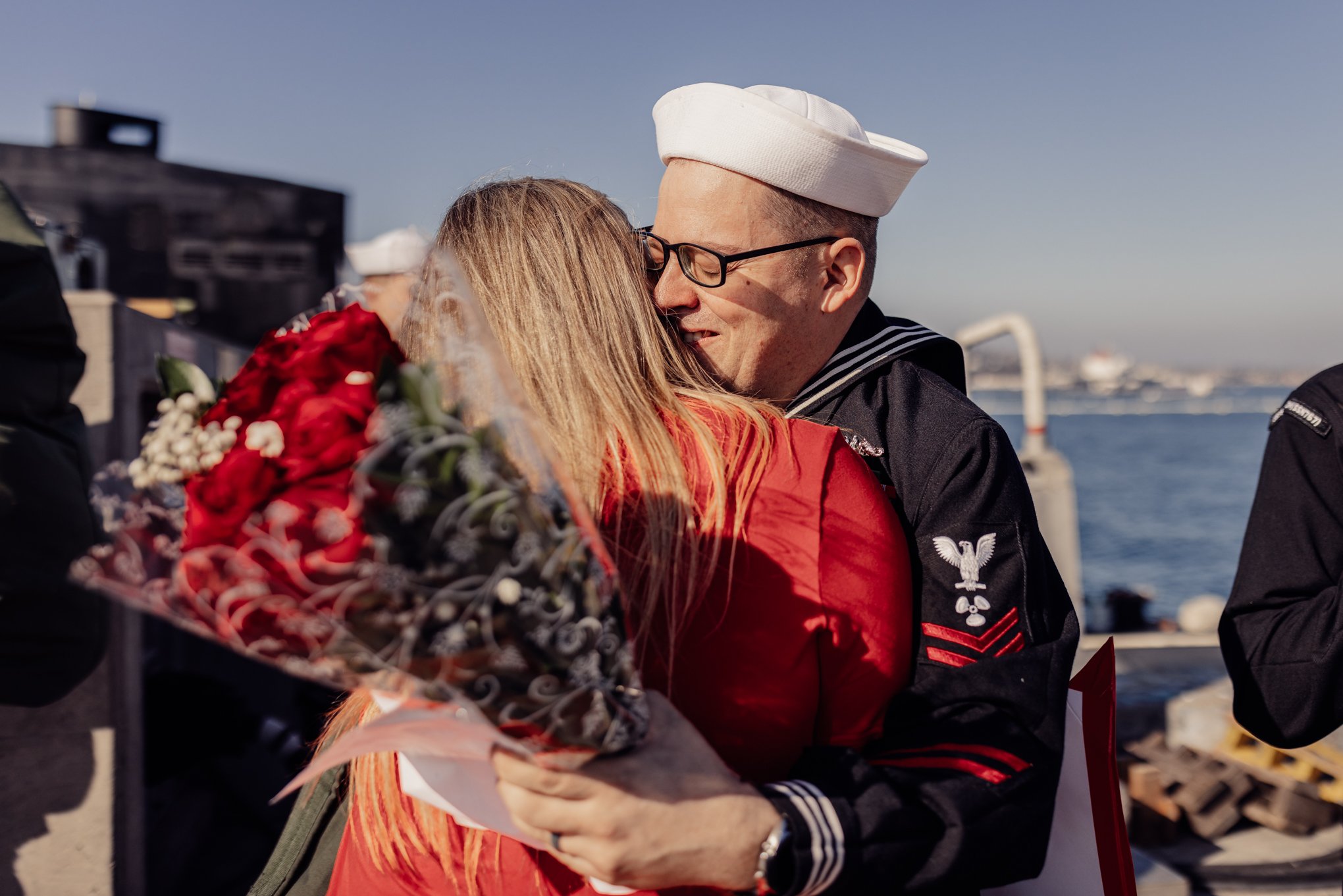 Sailor hugging wife for the first time in months after long navy deployment 