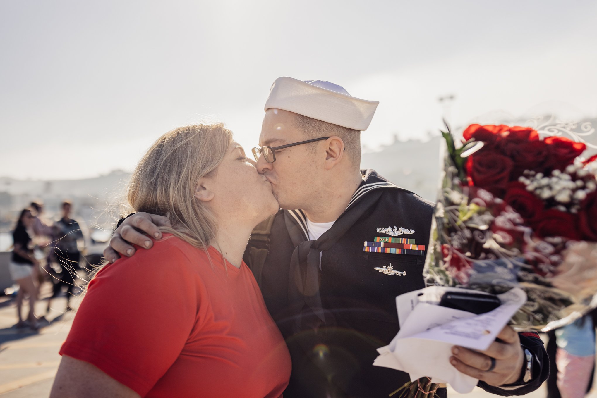 Kissing couple at military Homecoming 