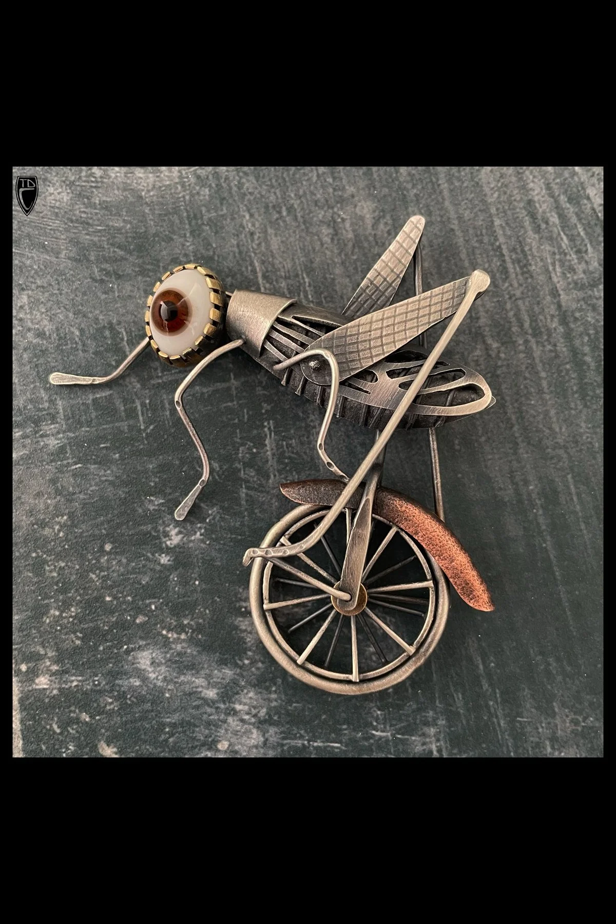 "Why Couldn't  a Big Brown Eyed Grasshopper Ride a Unicycle?", Sterling Silver, Brass, Copper and Antique Doll Eye Brooch/Pendnant
