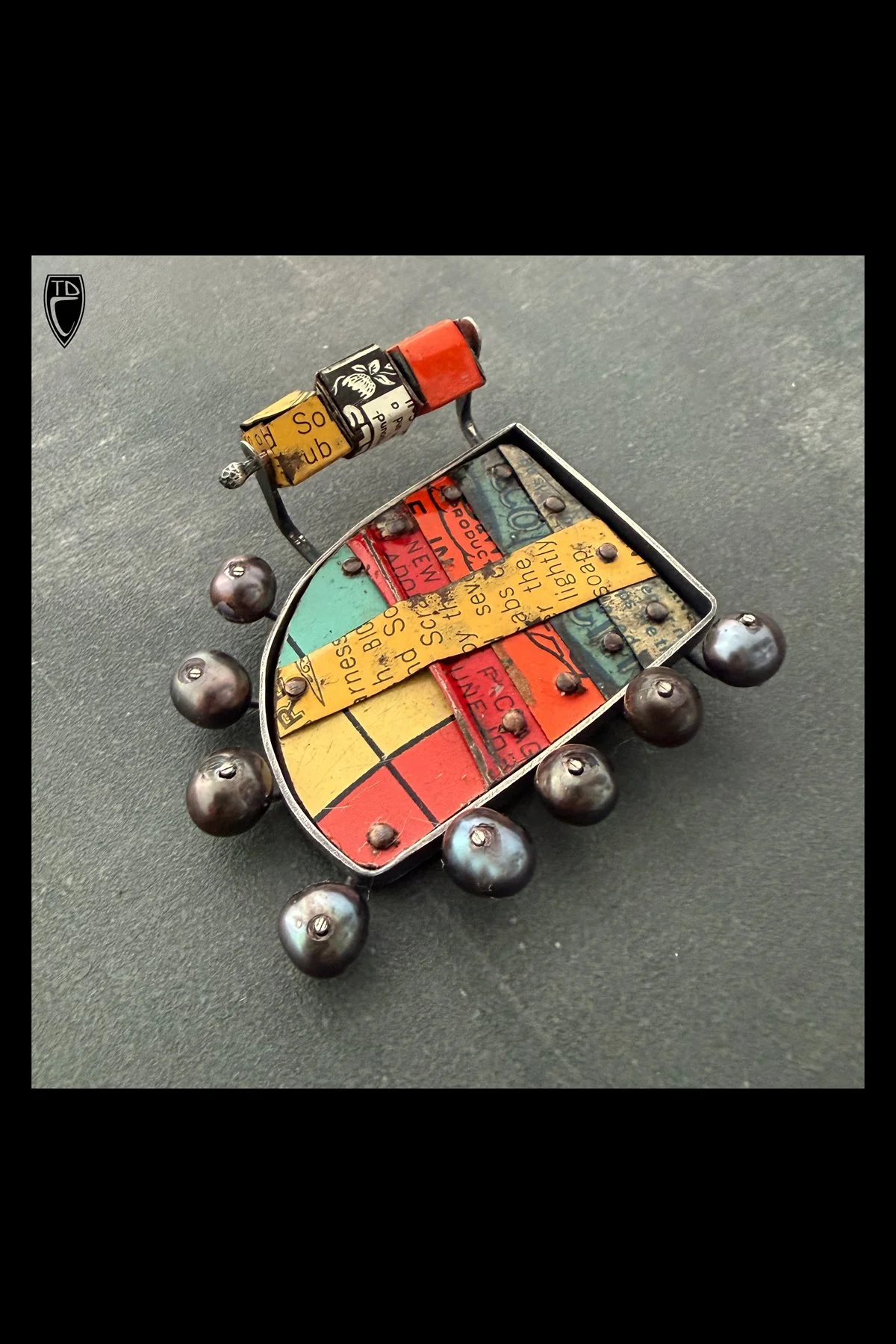 "Carnival Game", Sterling Silver, Antique Tin Lithography and Black Pearl Kinetic Cube Brooch