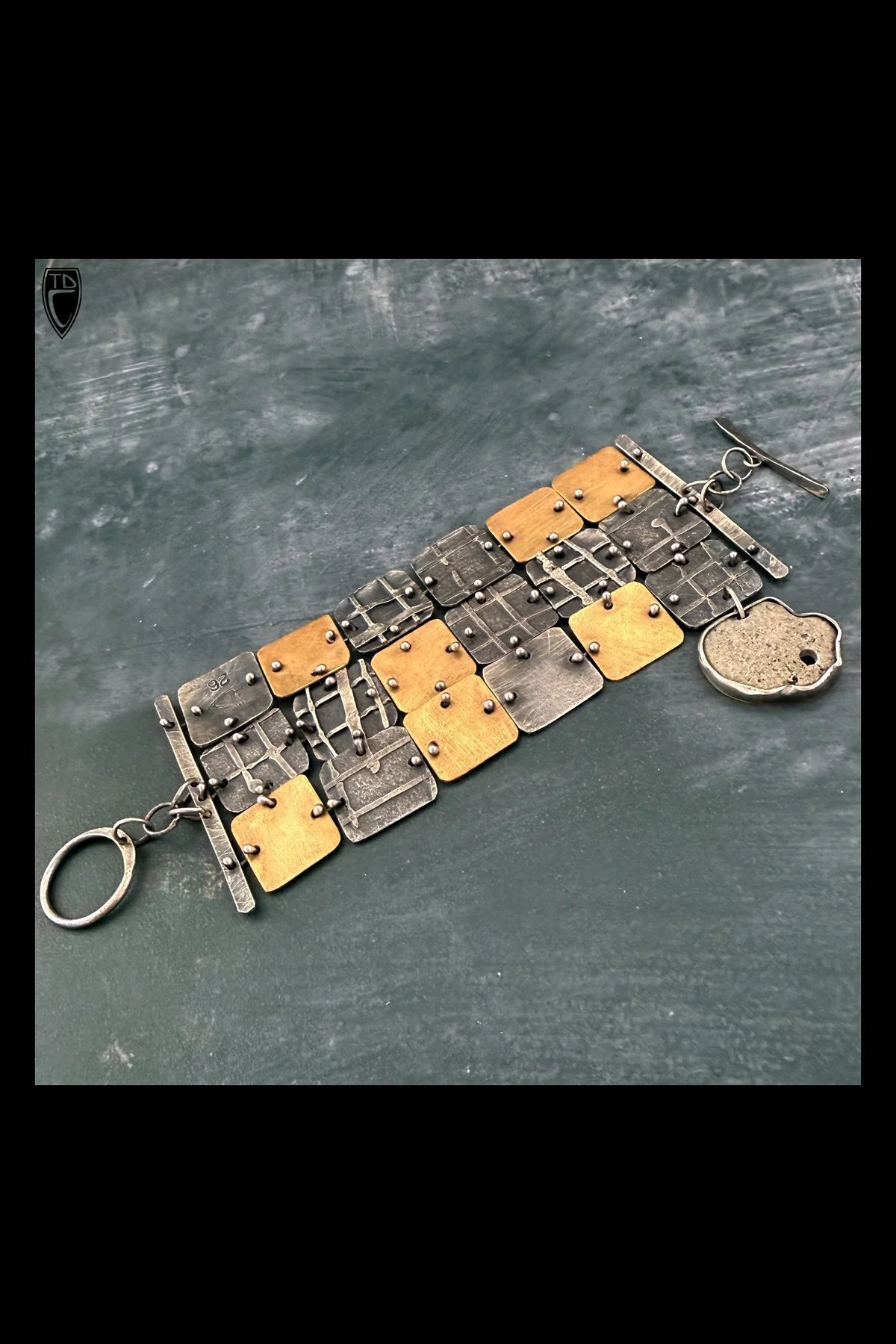 Sterling Silver, Brass and Bezel Set Natural Hag Stone Toggled Panel Bracelet