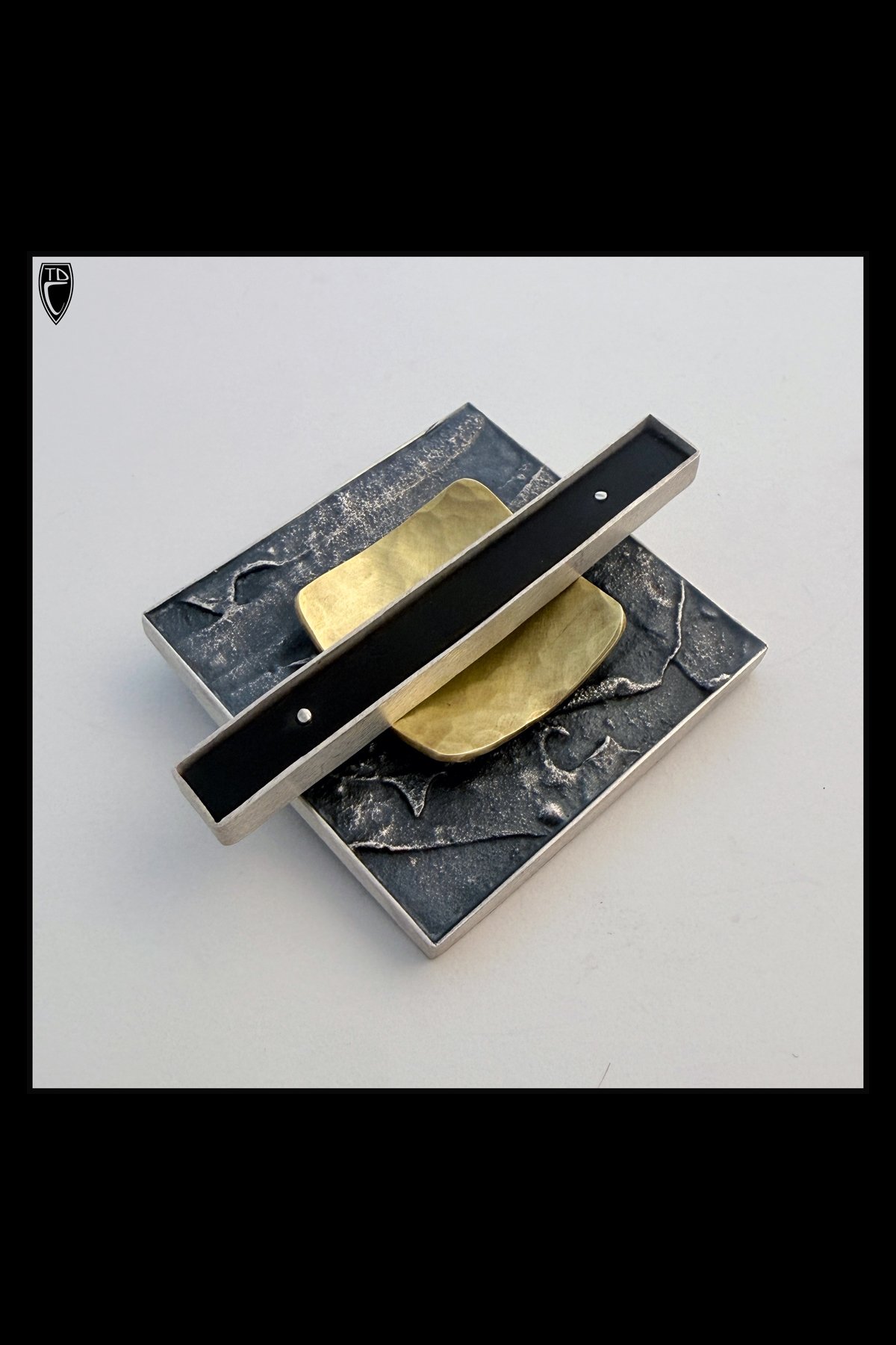"Datum", Fused, Framed and Textural Sterling Silver, Hammered Brass and Ebony Architectural Lapel Pin
