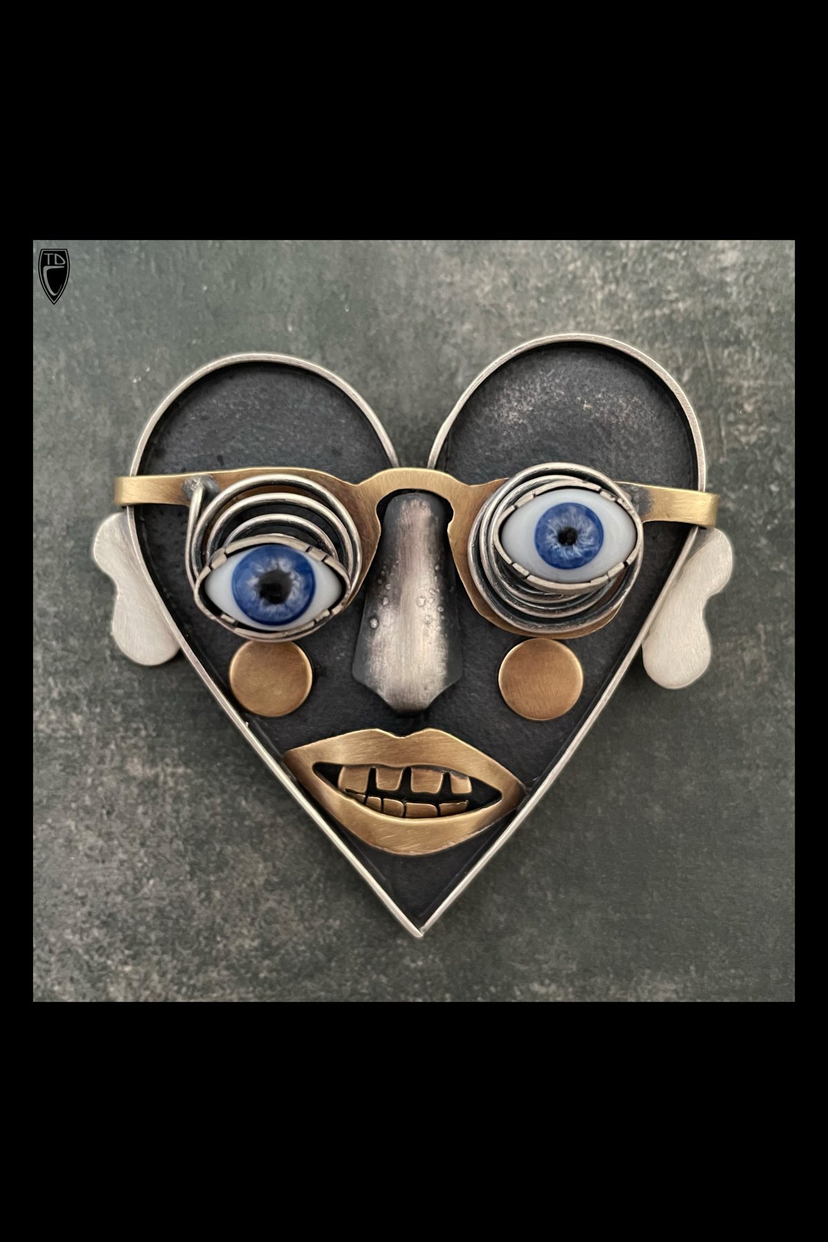 "A Kid at Heart", Sterling Silver, Brass, Antique Glass Doll Eyes and Steel Heart Brooch Pendant