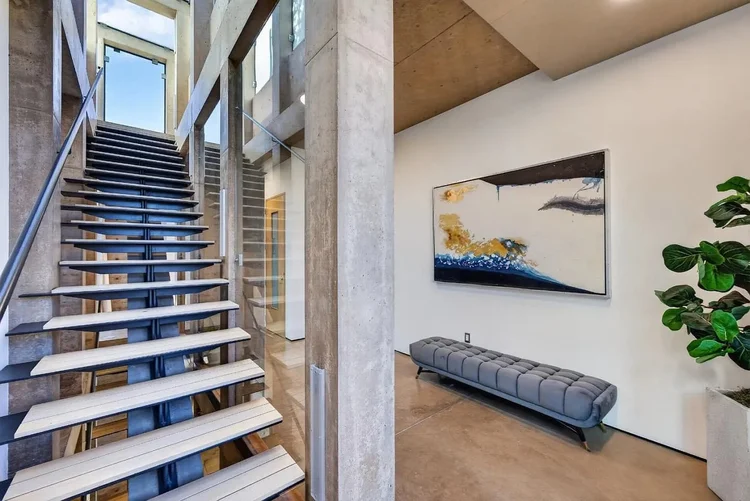 Floating stair and gallery wall at 102 University Ave #3C, Palo Alto