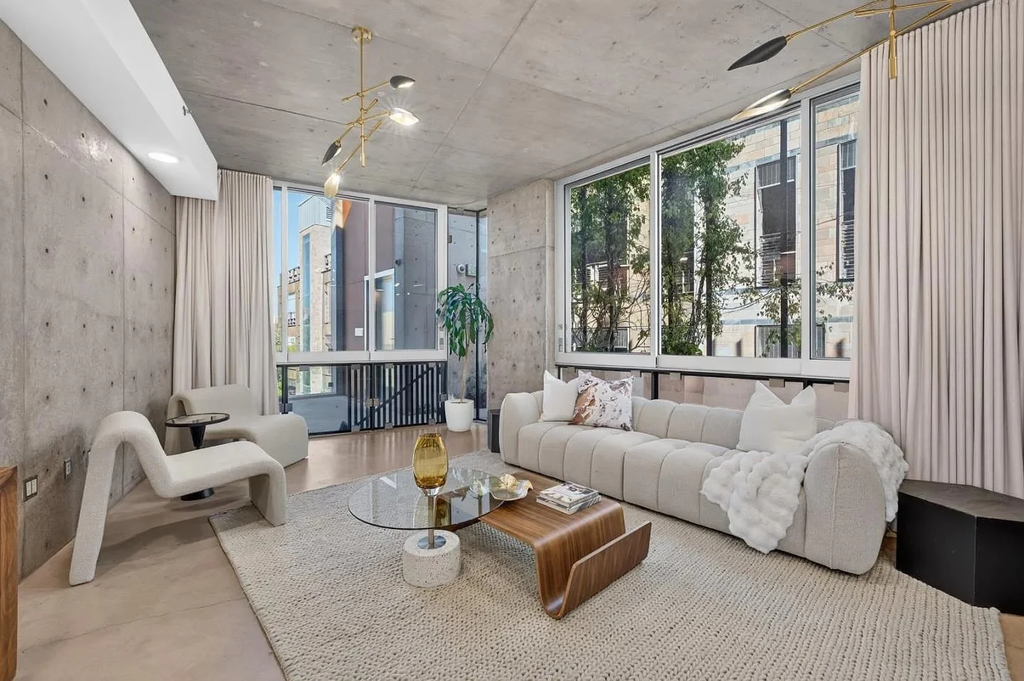 Staged living room with concrete walls and floor-to-ceiling glass at 102 University Ave #3C in Palo Alto