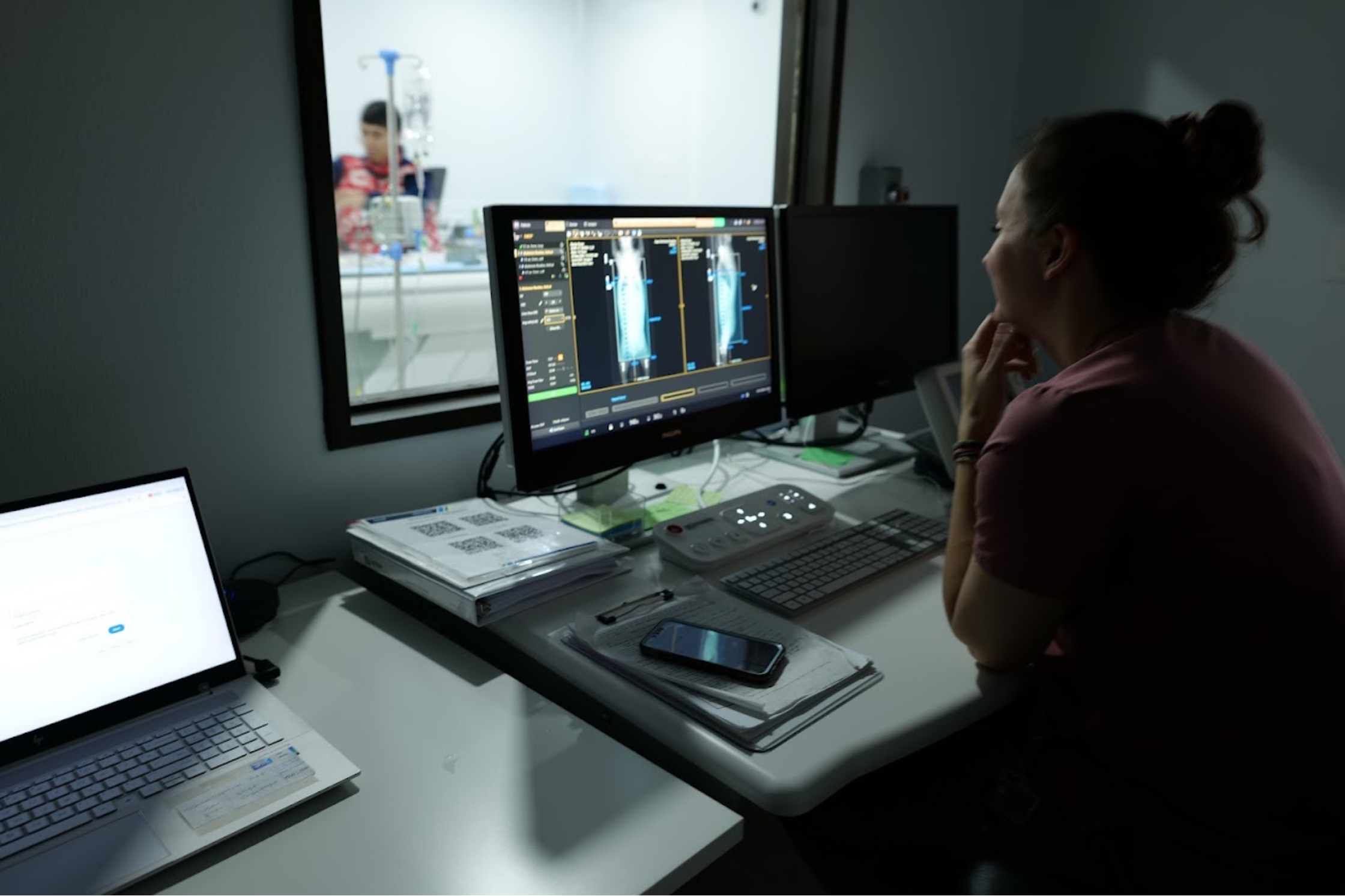 A veterinary imaging professional reviewing advanced diagnostic images at Sage Veterinary Imaging in Sandy, Utah
