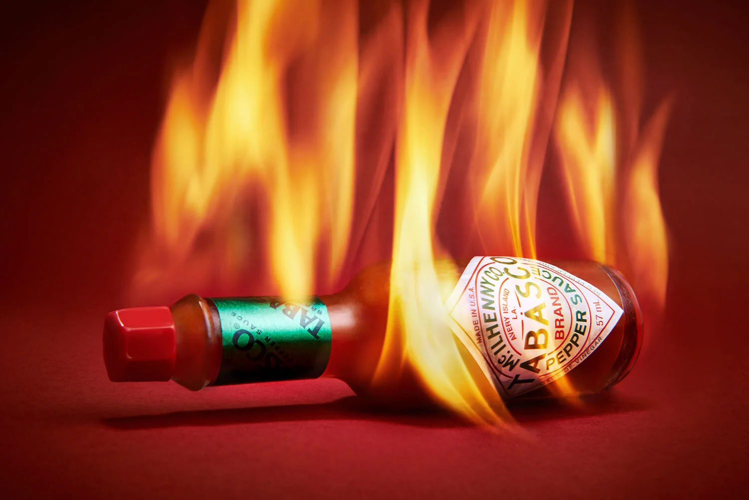 Still life imagery from the archive of cult brand Tabasco Pepper Sauce. I set the bottle on fire to help demonstrate its spicy nature, shot it on a red background close and wide angle to help warp the image and create a more dynamic shot. Food photo…