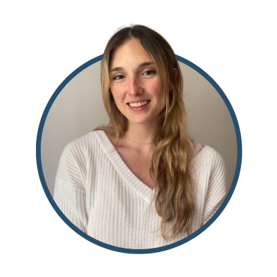 Woman wearing a white sweater inside a circular frame, smiling at the camera, with long blonde hair.