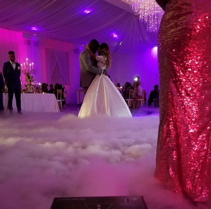 A bride and groom sharing their first dance at their wedding reception. Options added: Dance in the cloud and LED uplighting.