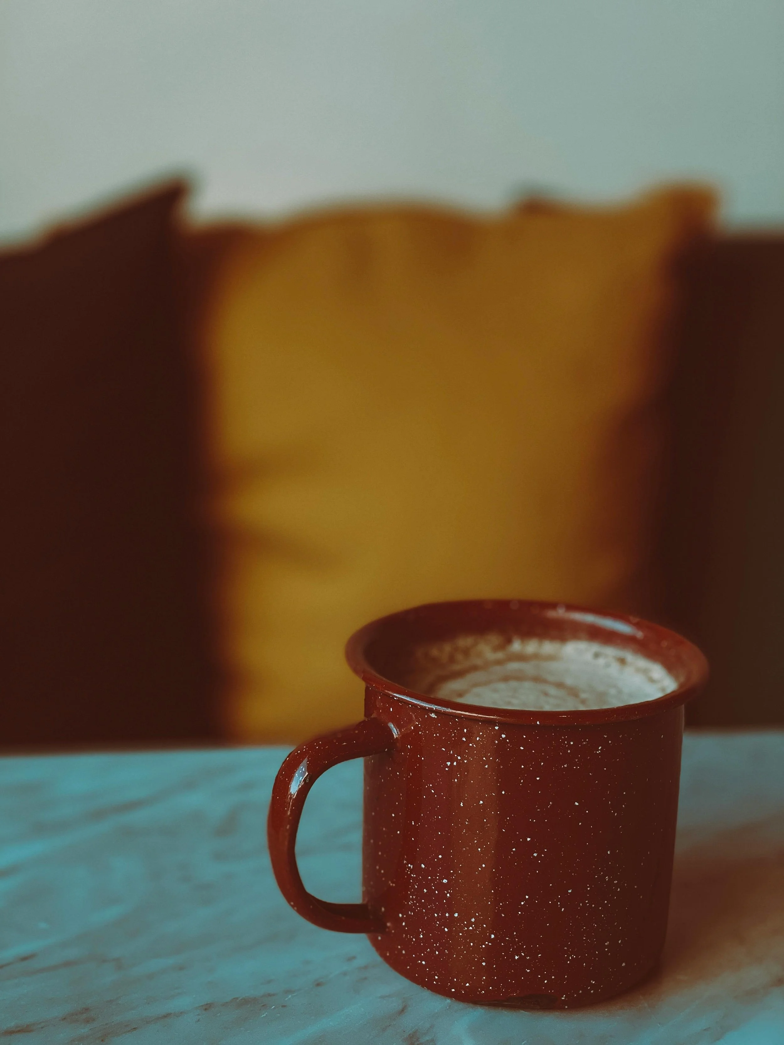 A red mug containing dandelion coffee made from roasting its roots. The recipe is simple to make and delicious.