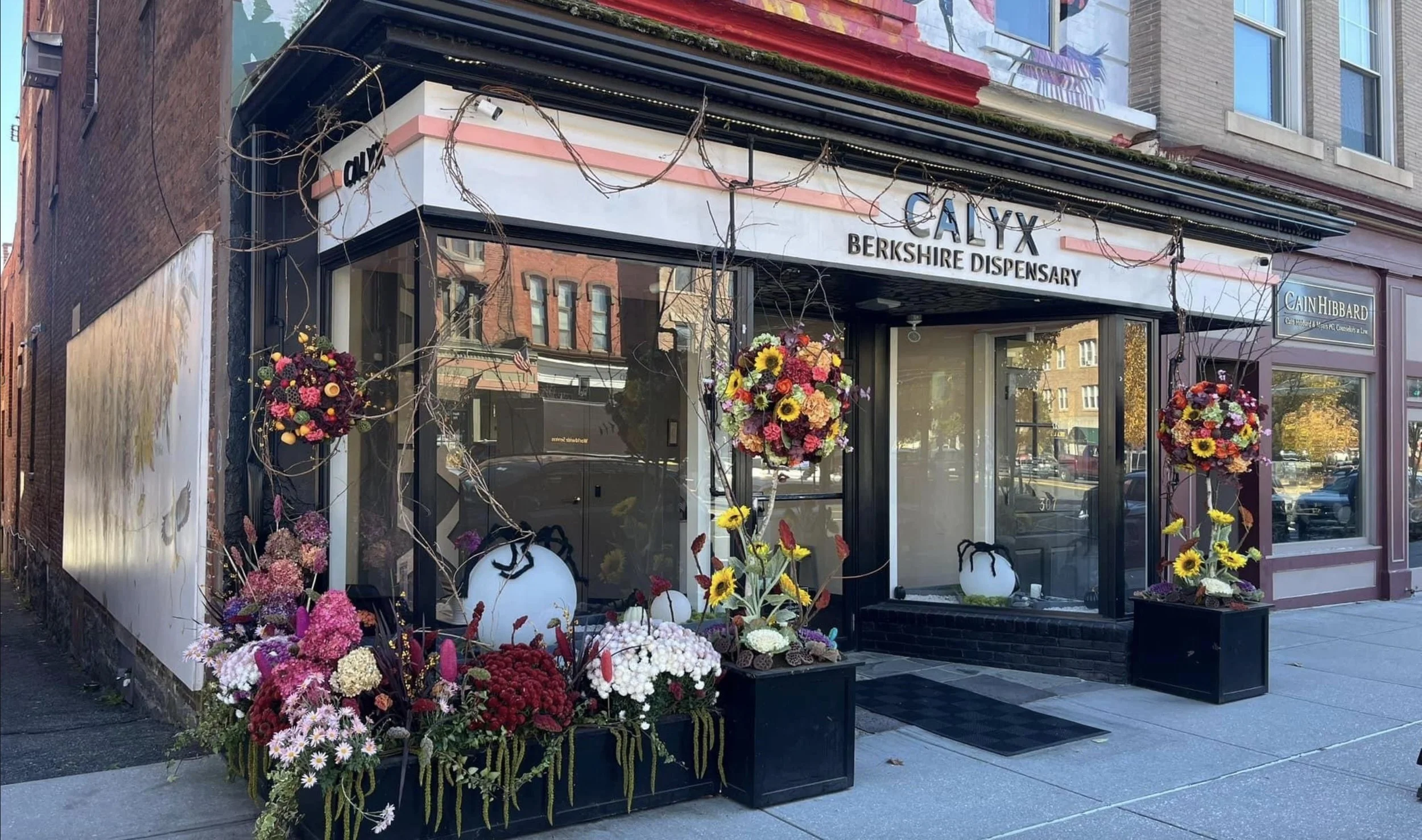 storefront with flowers outside and the sign Calyx Berkshire Dispensary.