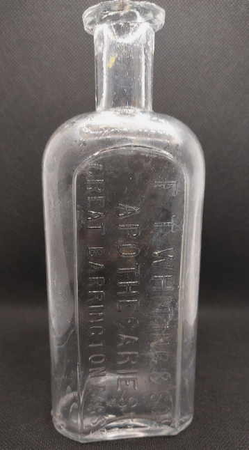 Embossed glass medicine bottle from F.T. Whiting & Son Apothecaries of Great Barrington