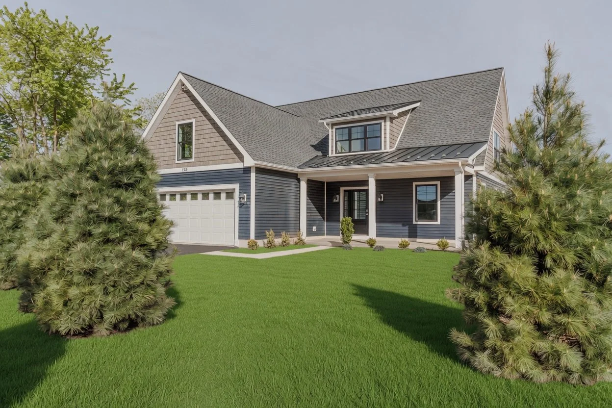 Front view of a blue house with a gray roof, a two-car garage, and a well-maintained green lawn with trees and bushes.
