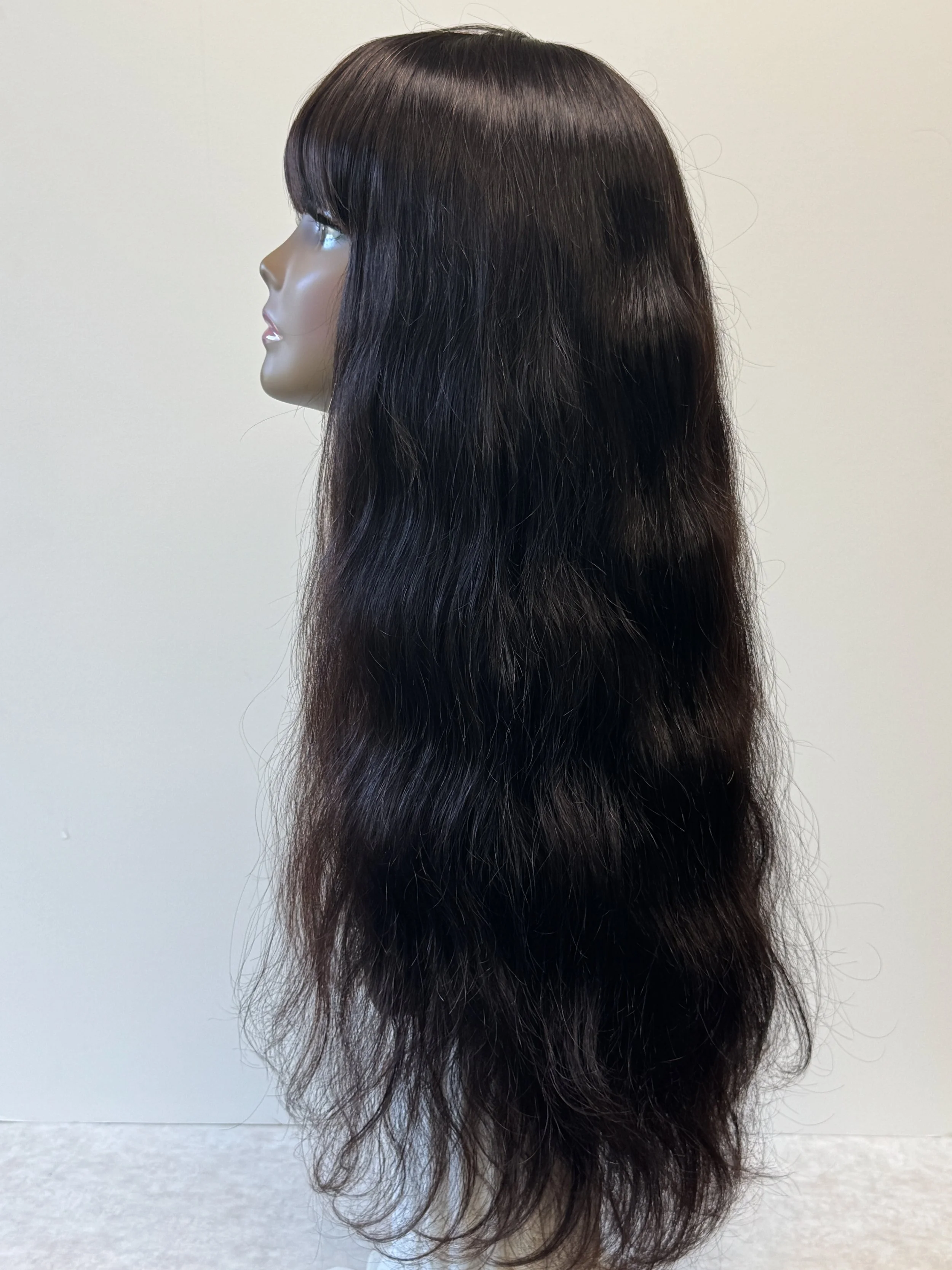 Side view of a 24-inch natural-color Virgin Human Hair wig showing full bangs, long hair length, and natural texture.1.JPG