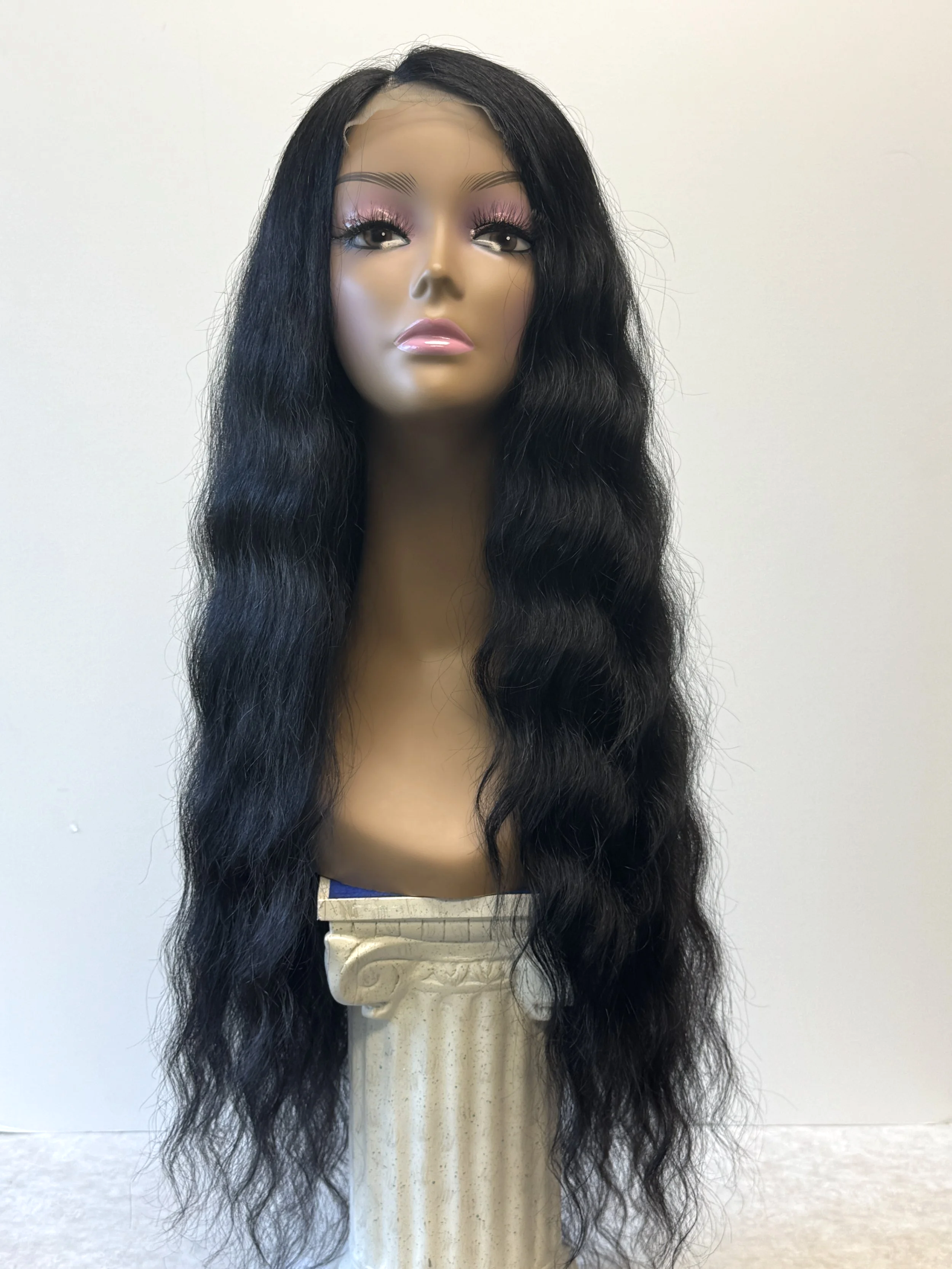 Black+26-inch+Virgin+Human+Hair+closure+wig+with+full%2C+loose+cascading+waves%2C+shown+on+a+model+from+the+front..png