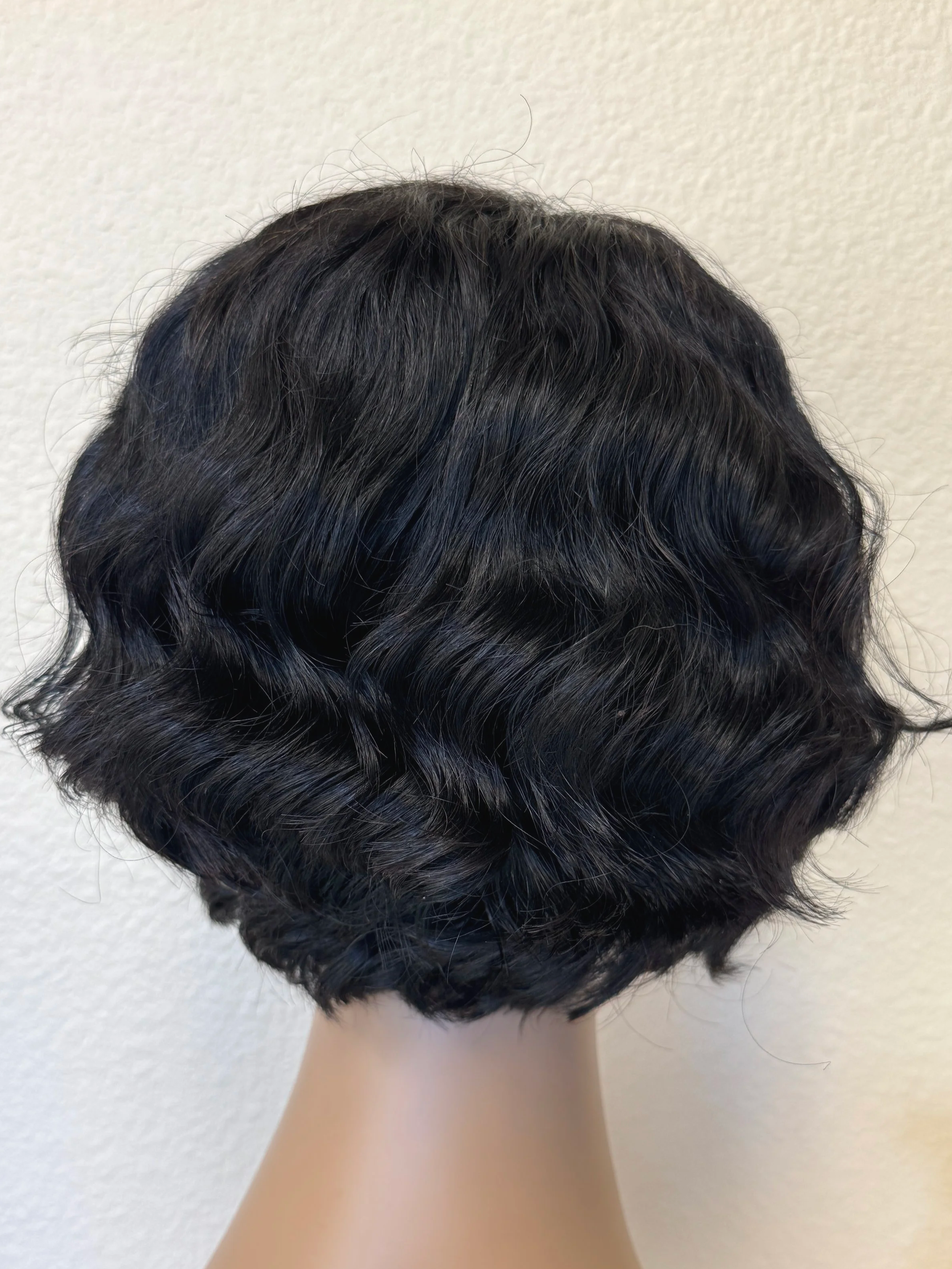 back+view+ofnatural+black+1B+human+hair+bob+wig+with+soft+loose+waves+and+rounded+volume+around+the+face..png