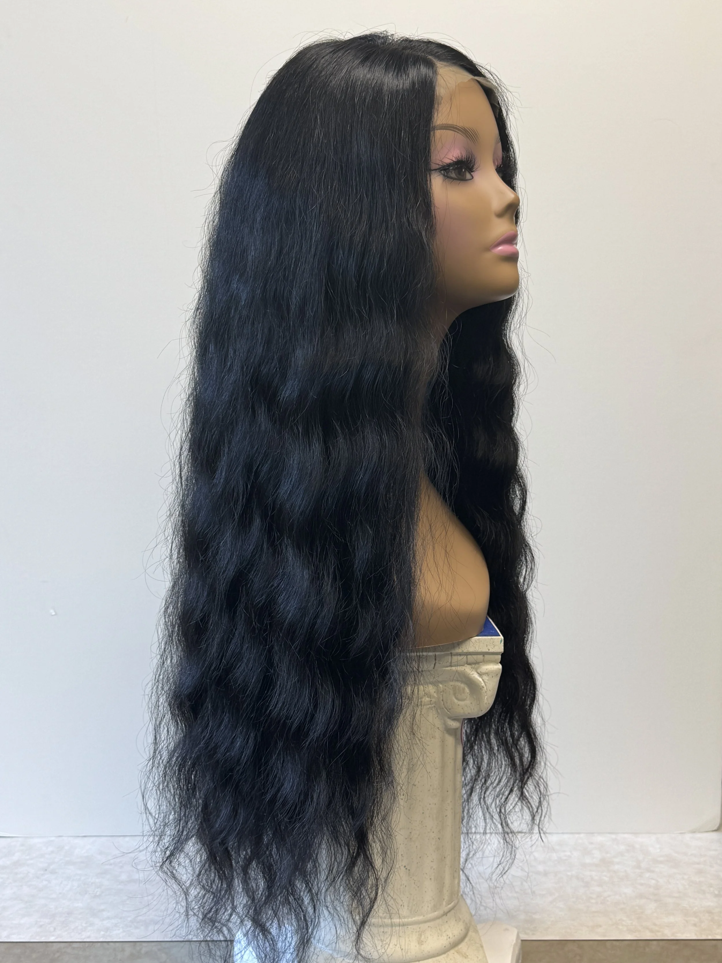 Side view of a black 26-inch loose wave human hair wig on a mannequin, showing its long cascading waves and natural fullness..JPG