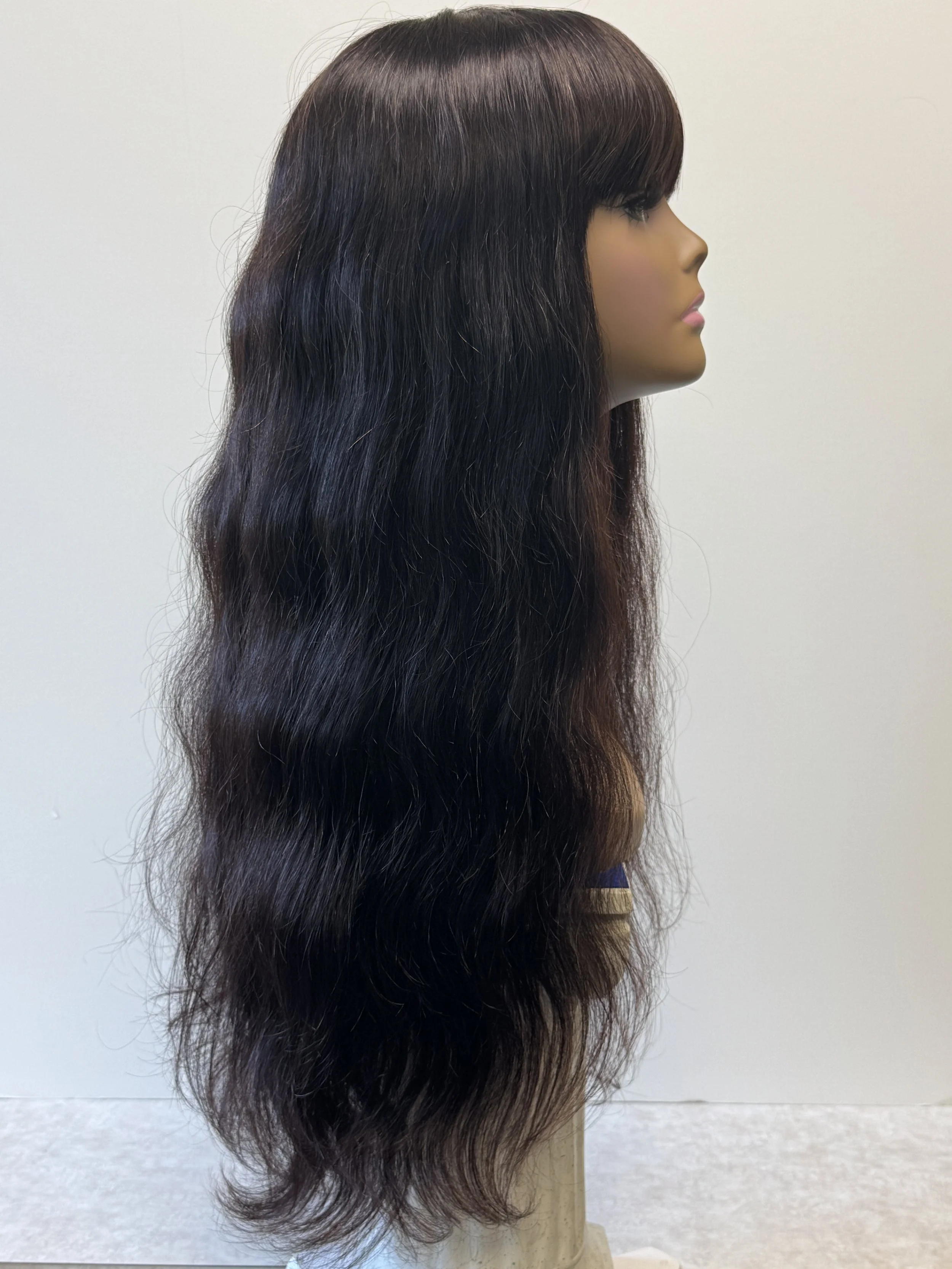 Side view of a 24-inch natural-color Virgin Human Hair wig showing full bangs, long hair length, and natural texture..JPG