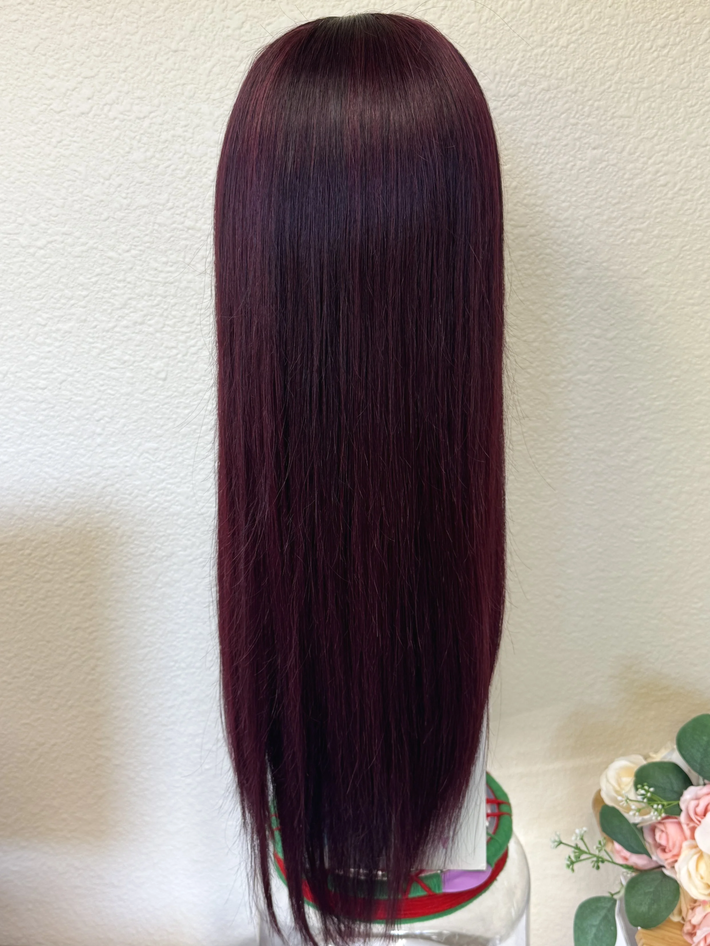 Black+Wine+straight+Remy+human+hair+wig+with+full+bangs%2C+deep+burgundy+color%2C+and+naturally+thin+tapered+ends+displayed+on+a+mannequin.back+view.png