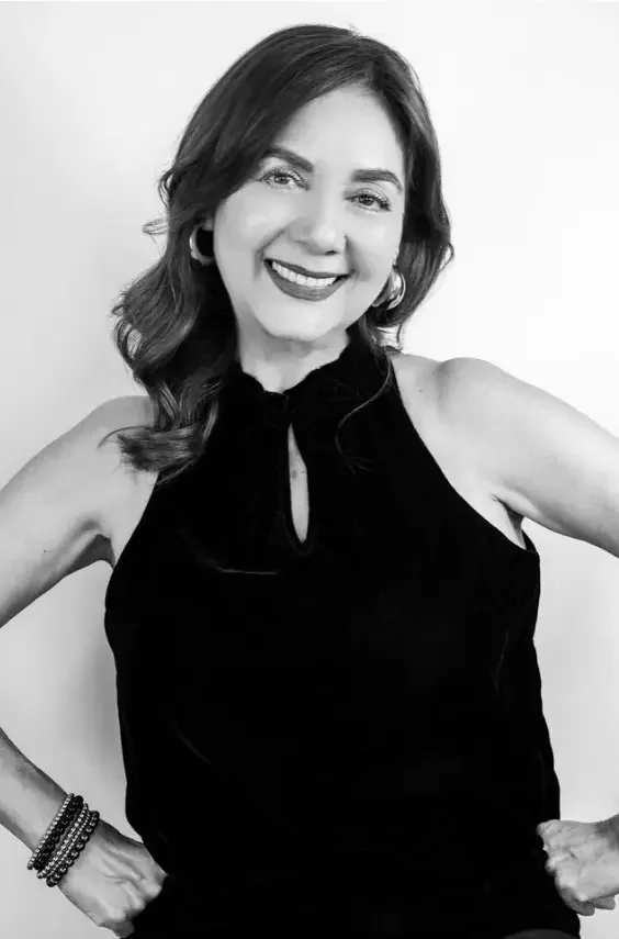 Elvia, expert red hair colorist at Cristophe Salon Beverly Hills, specialist in precision cutting, curly perms, and couture styling for a diverse clientele.