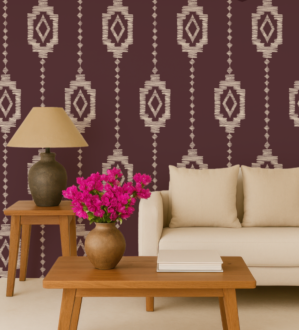 Living room with a beige sofa, wooden coffee table with a stack of books, pink flowers in a vase, a side table with a lamp, and patterned purple and beige wallpaper.