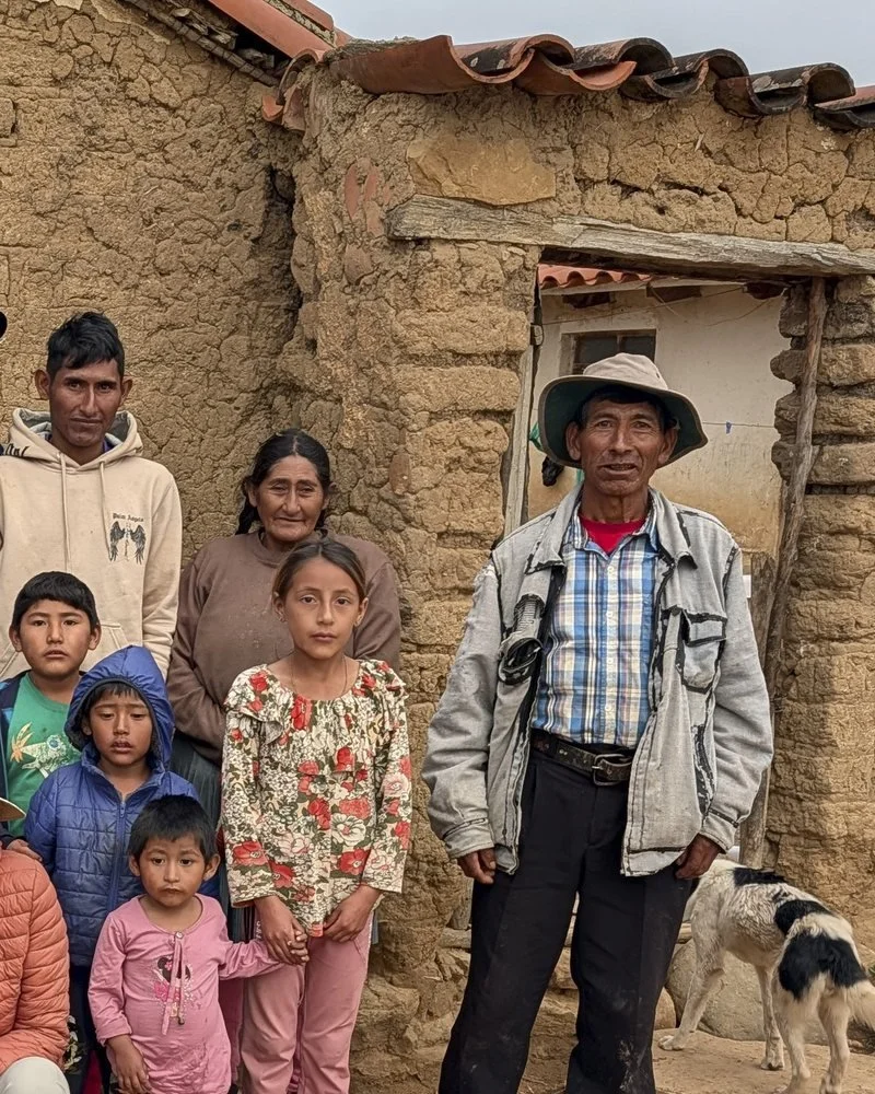 A family outside their adobe home in San Julián Bajo