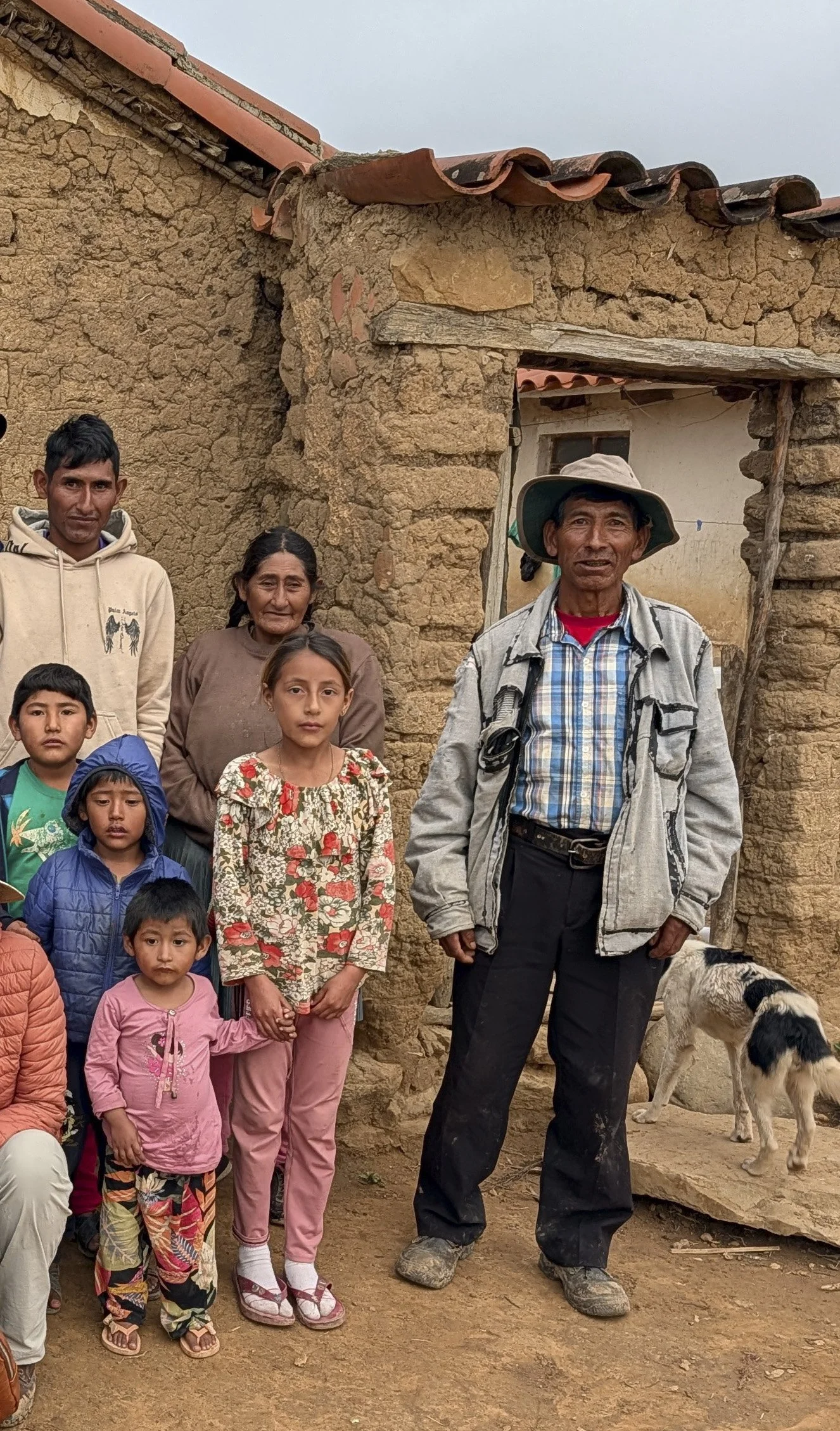 A family outside their adobe home in San Julián Bajo