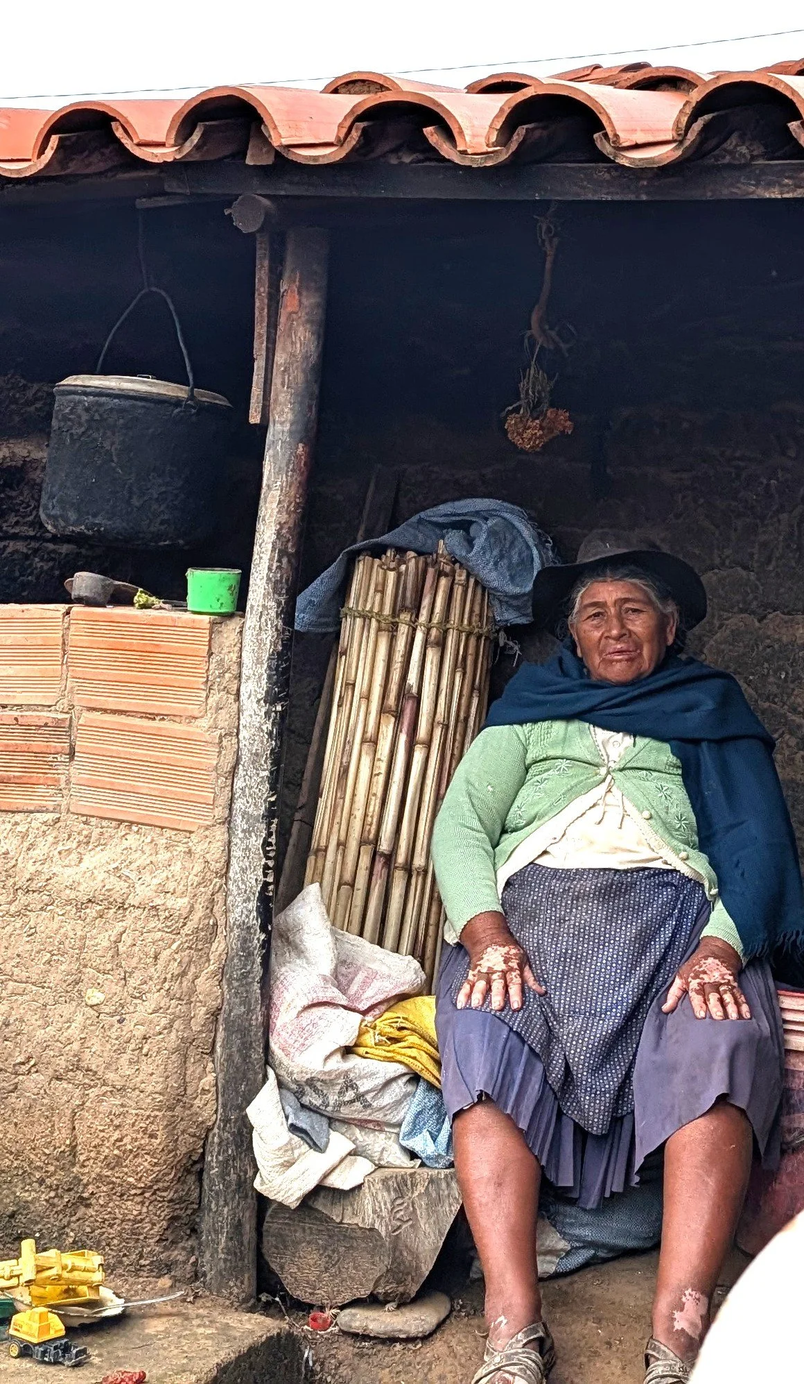 A resident of San Julián Bajo sitting in their home